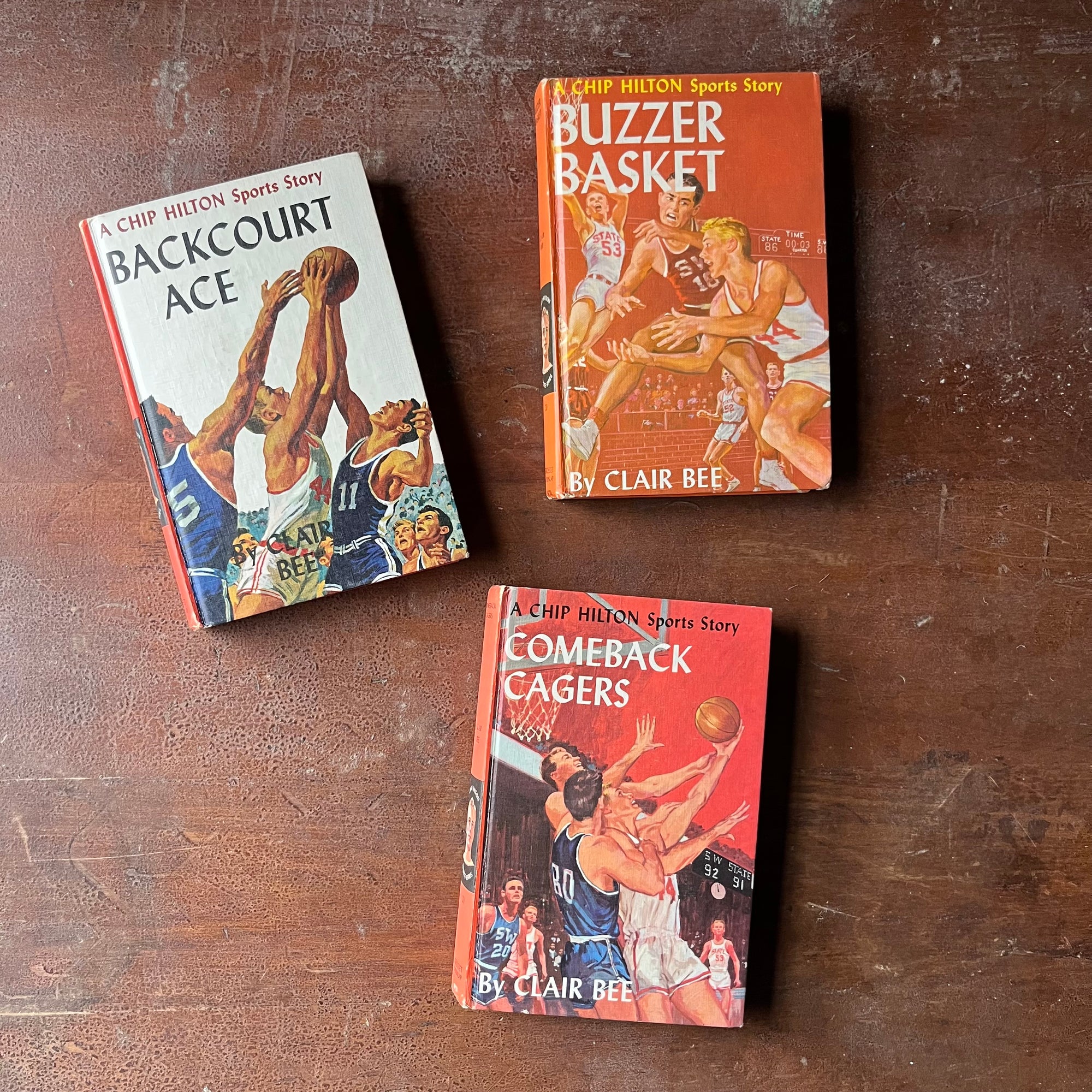 A Chip Hilton Sports Story Book Set-Backcourt Ace, Buzzer Basket & Comeback Cagers by Clair Bee-vintage children's chapter books-view of the front covers with images of teams playing basketball