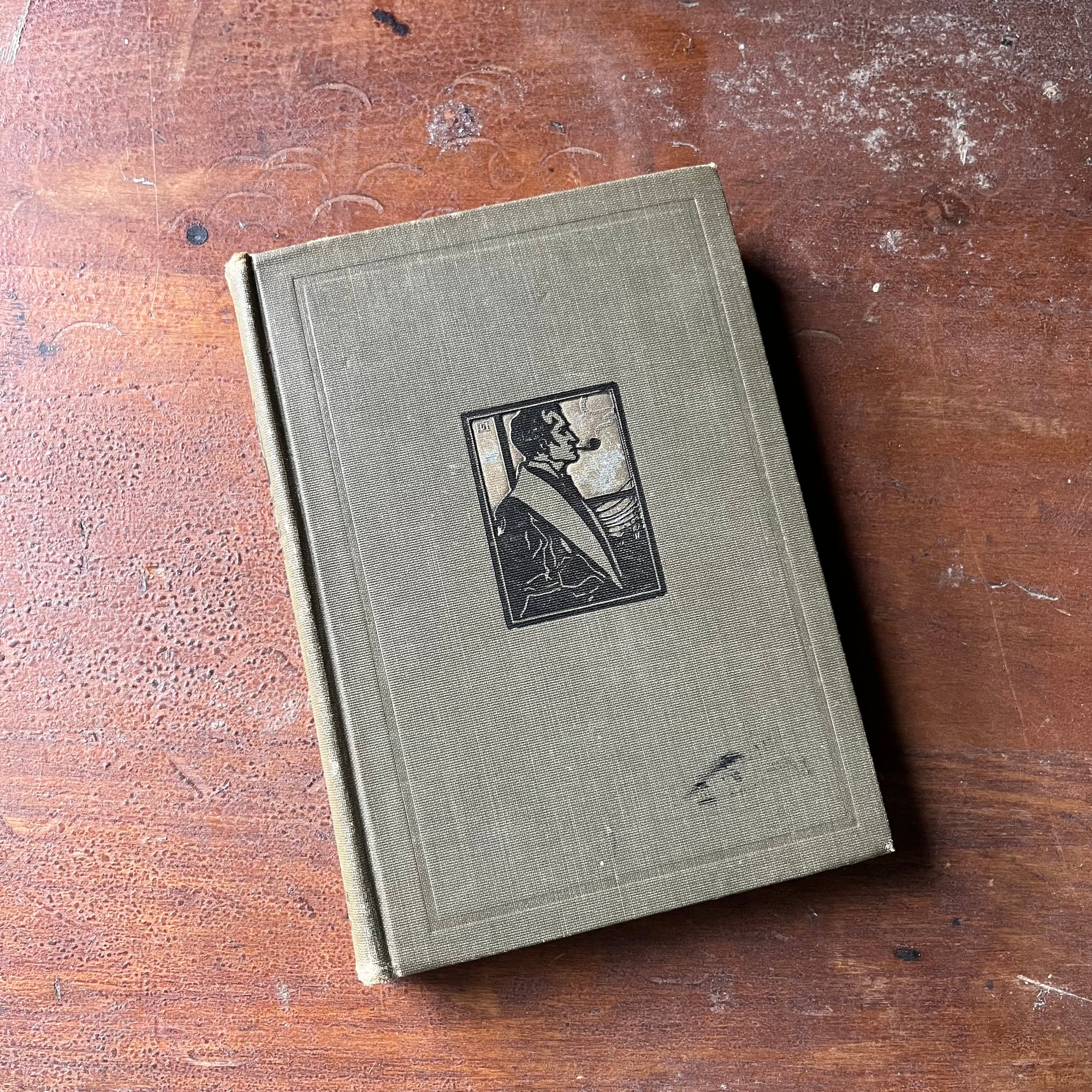 vintage mystery book - Conan Doyle's Best Books in Three Volumes-The White Company-Beyond the City-Sherlock Holmes Edition written by Sir Arthur Conan Doyle - view of the embossed front cover with a small illustration of Sherlock Holmes Smoking a Pipe