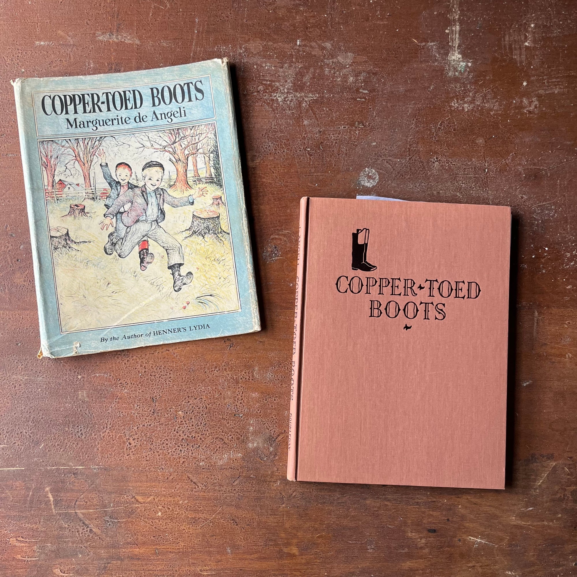 Copper-Toed Boots written & Illustrated by Marguerite de Angeli-1938 Edition with Dust Jacket-Autographed Edition-vintage picture book-view of the front cover with an embossed title and dust jacket off to the side