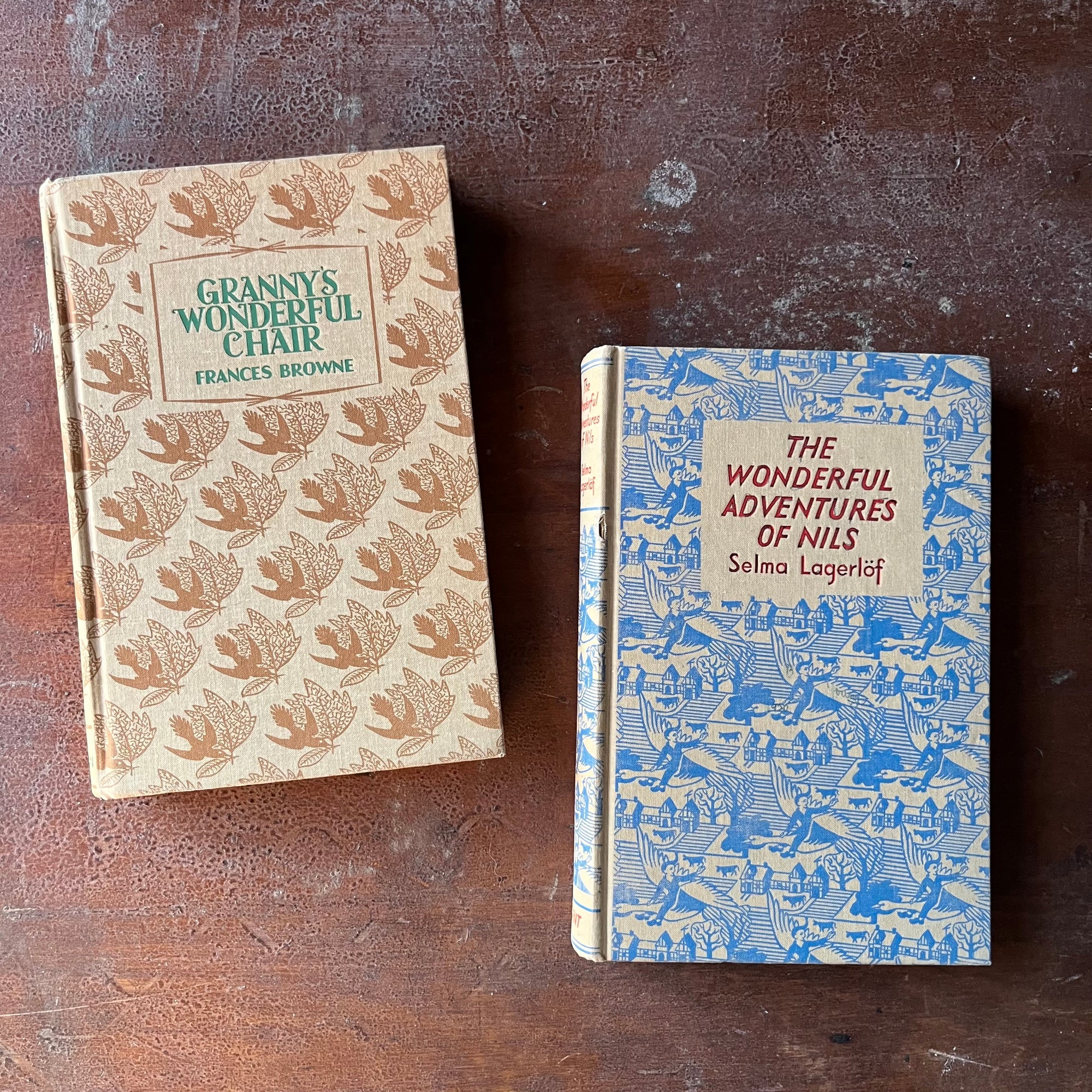 vintage children's chapter books - Dent Dutton Children's Illustrated Classics - The Wonderful Adventures of Nils written by Selma Lagerlof and Granny's Wonderful Chair written by Frances Browne - view of the decorative front covers in brown & blue