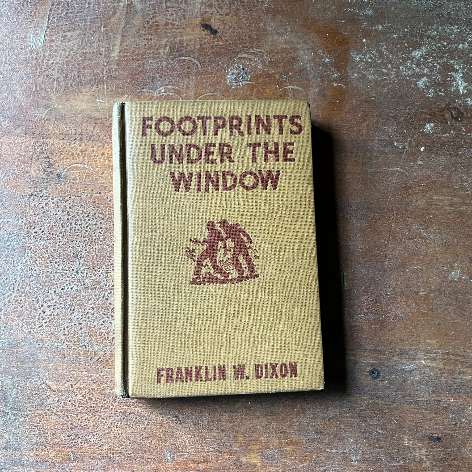 vintage children's chapter book, vintage adventure book for boys, Hardy Boys Mystery - Footprints Under the Window #12 written by Franklin W. Dixon - view of the embossed front cover