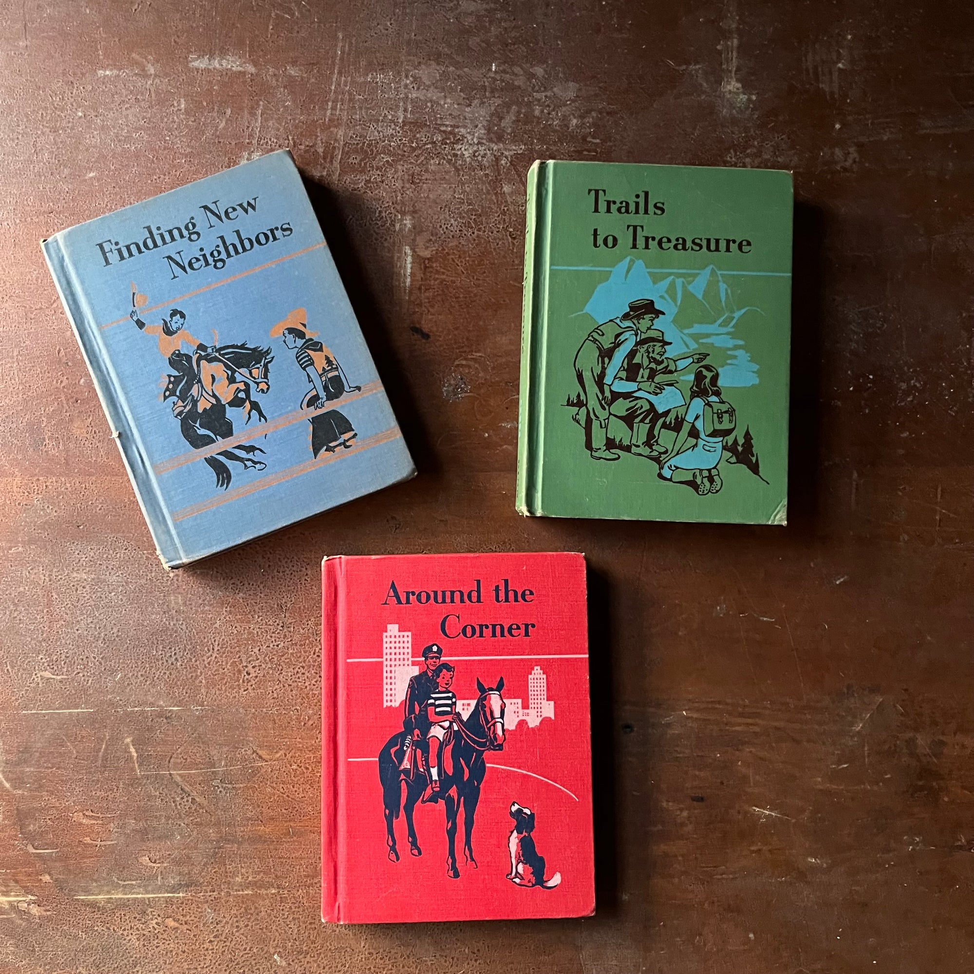 vintage elementary school books, vintage books learning to read - Ginn Basic Readers Vintage School Book Set-Around the Corner, Trails to Treasure, & Finding New Neighbors - view of the colorful front covers in red, green & blue