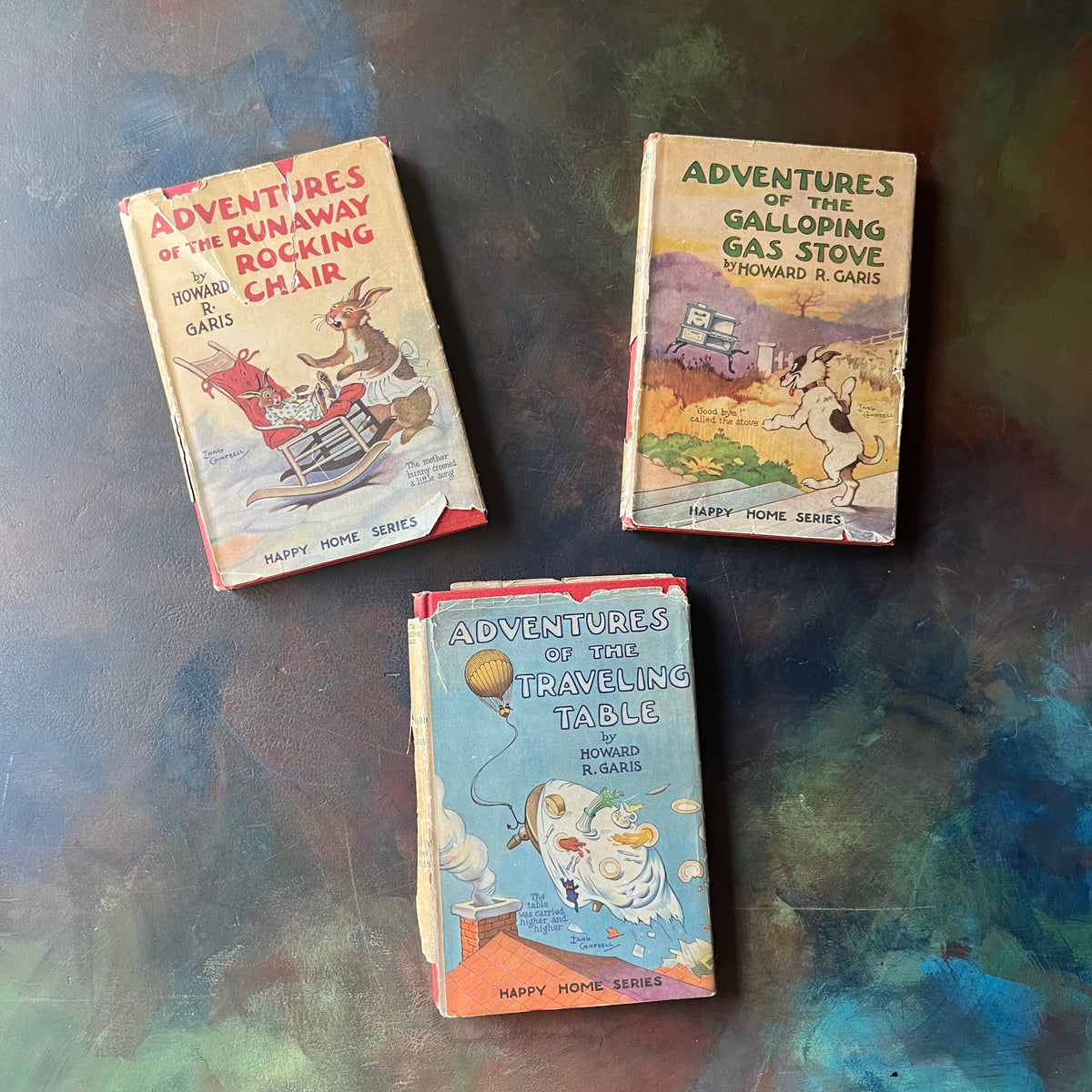 Happy Home Series Storybooks by Howard R. Garis-Adventures of the Runaway Rocking Chair-The Adventures of the Galloping Gas Stove-Adventures of the Traveling Table-view of the dust jacket's covers - note the worn & torn condition of the dust jackets