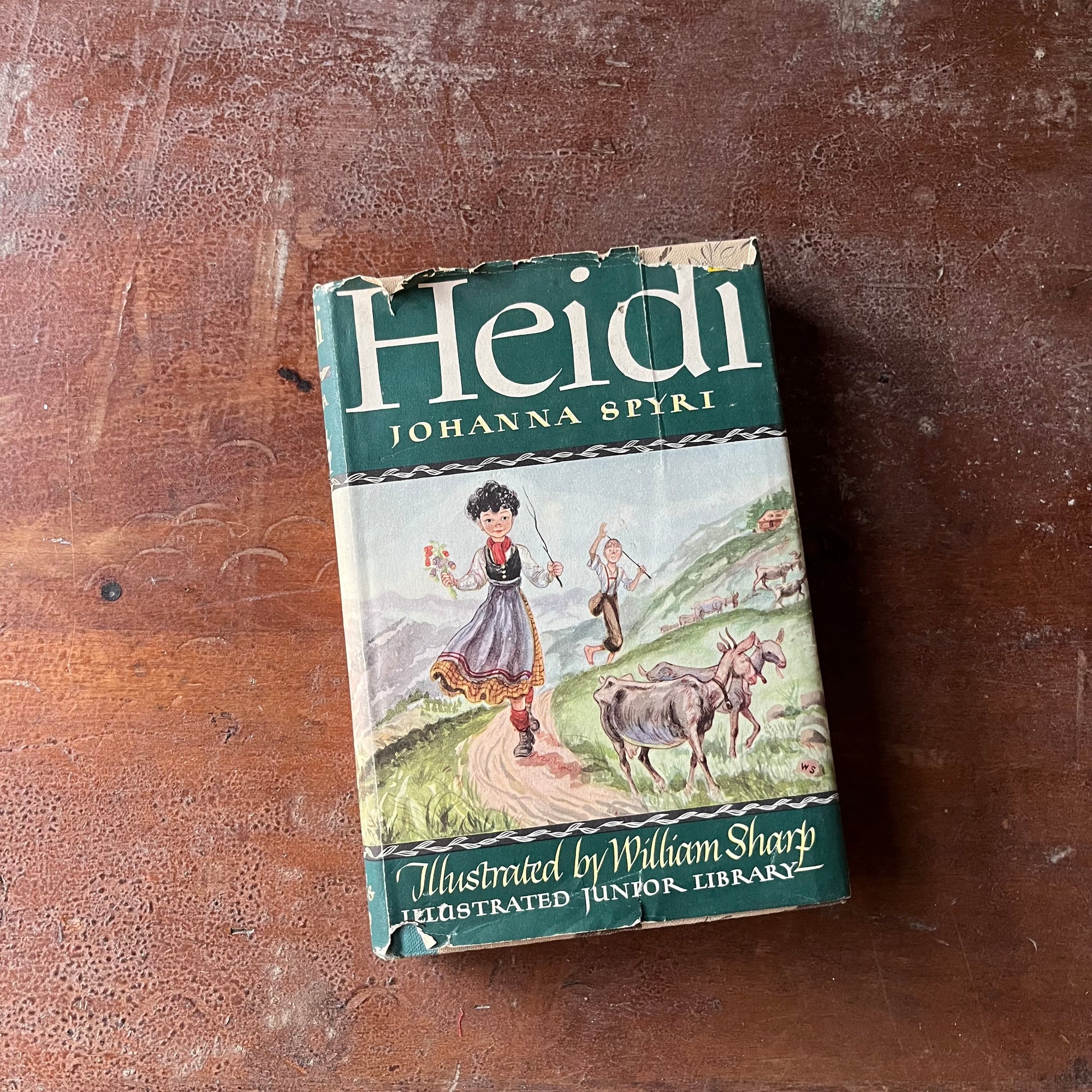 Illustrated Junior Library Editions-Heidi by Johanna Spyri with illustrations by William Sharp-vintage children's classic literature-view of the dust jacket's front cover with an illustration of Heidi with goats