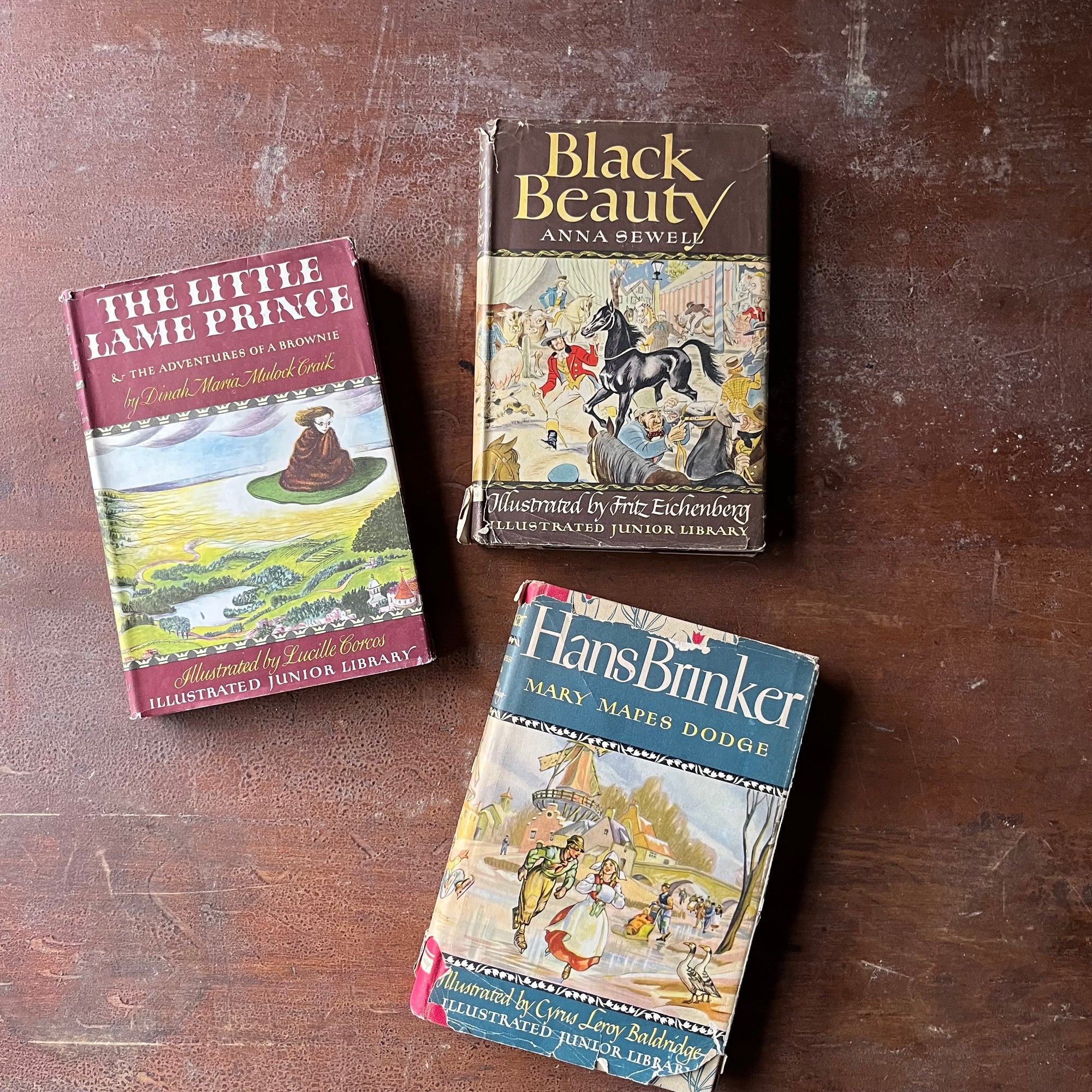 vintage children's classic literature - Illustrated Junior Library Series Book Set-Black Beauty written by Anna Sewell, The Little Lame Prince written by Dinah Maria Mulock Craik, & Hans Brinker written by Mary Mapes Dodge - view of the dust jacket's colorful front covers