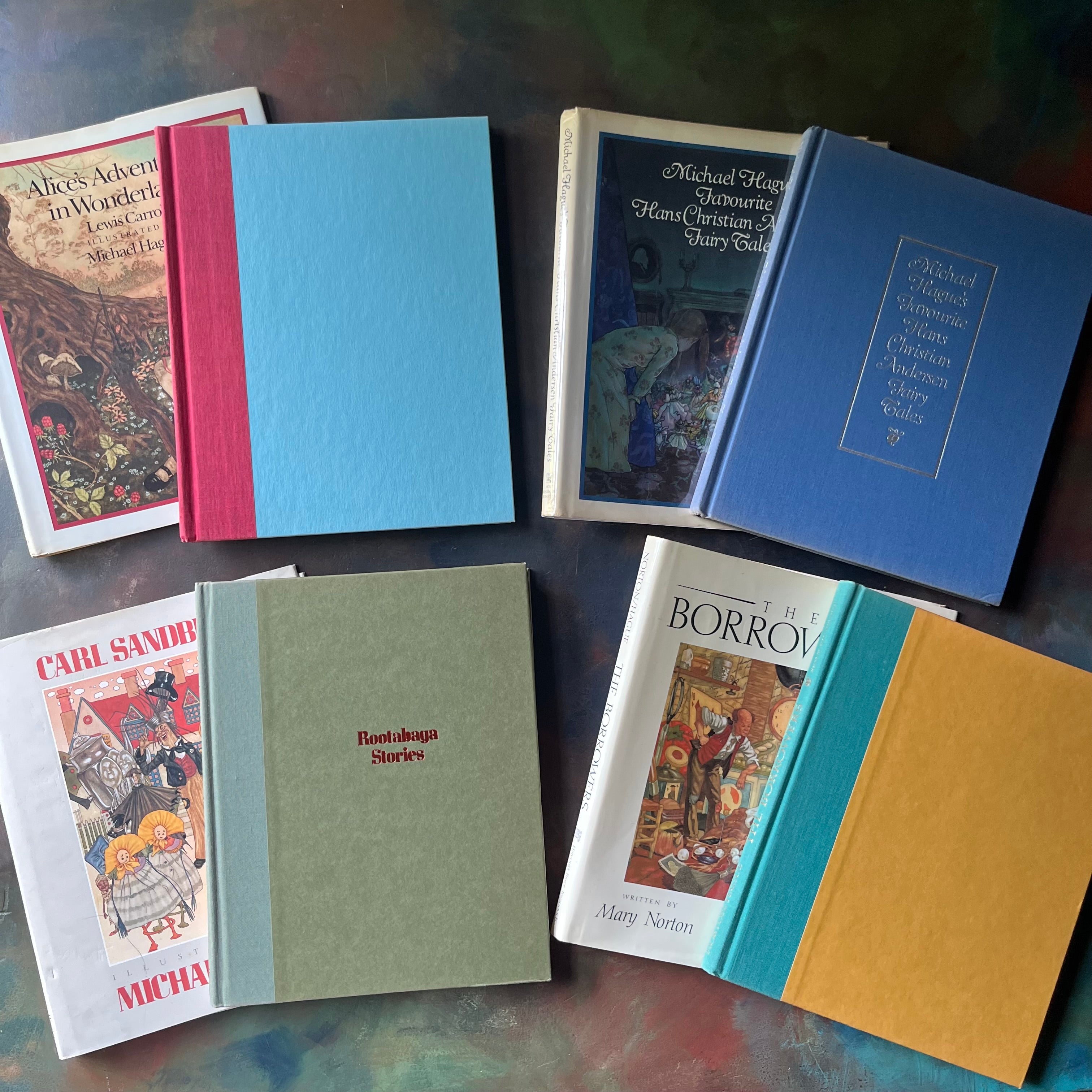 Bundle of Books illustrated by Michael Hague-Alice's Adventures in Wonderland-Michael Hague's Favourite Hans Christian Andersen's Fairy Tales-The Borrower's-Rootabaga Stories Part One-classic children's literature book set-view of the front covers
