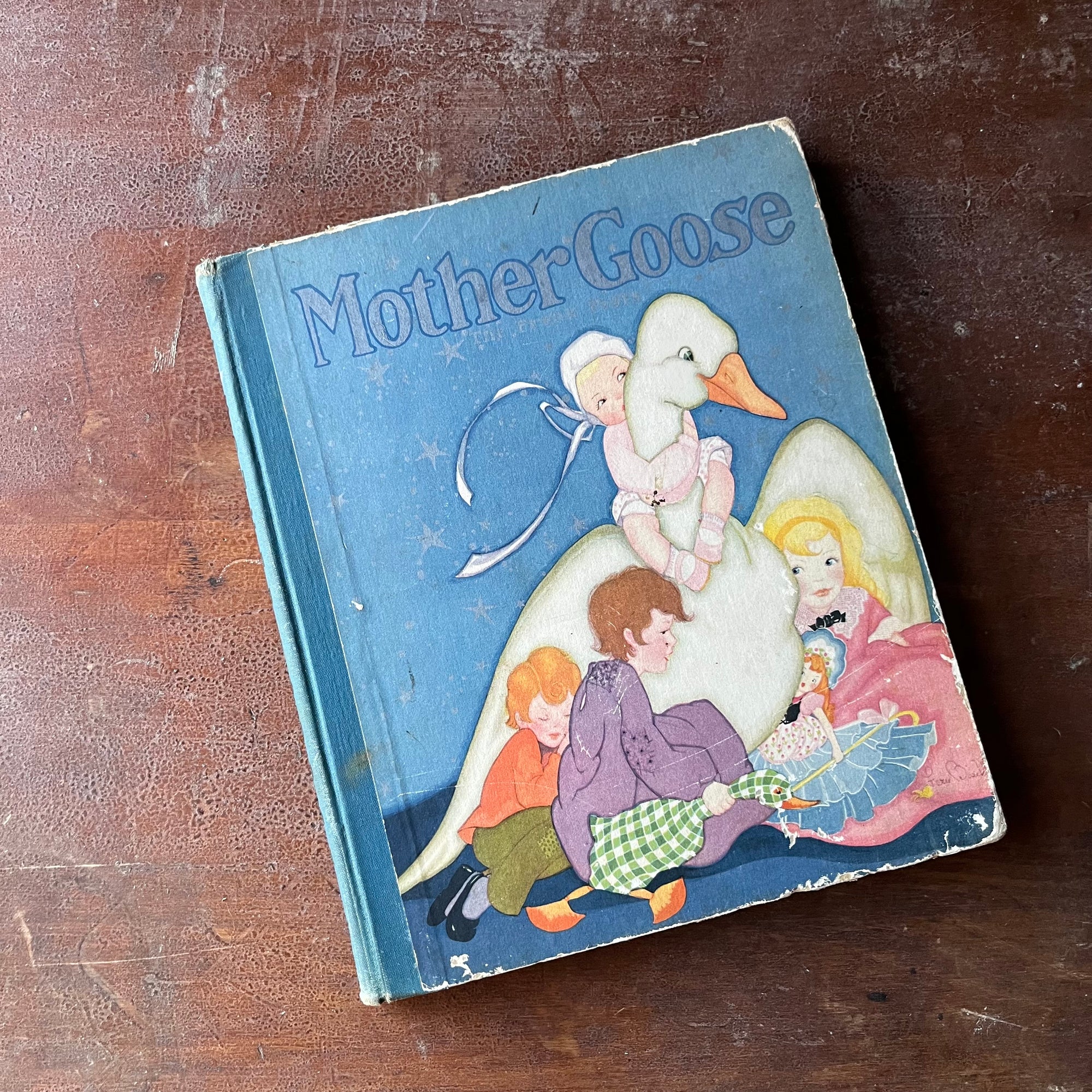 Mother Goose by Fern & Frank Peat-A 1929 Saalfield Publishing Company Edition-vintage children's nursery rhymes-view of the front cover in a gorgeous blue with Mother Goose surrounded by children