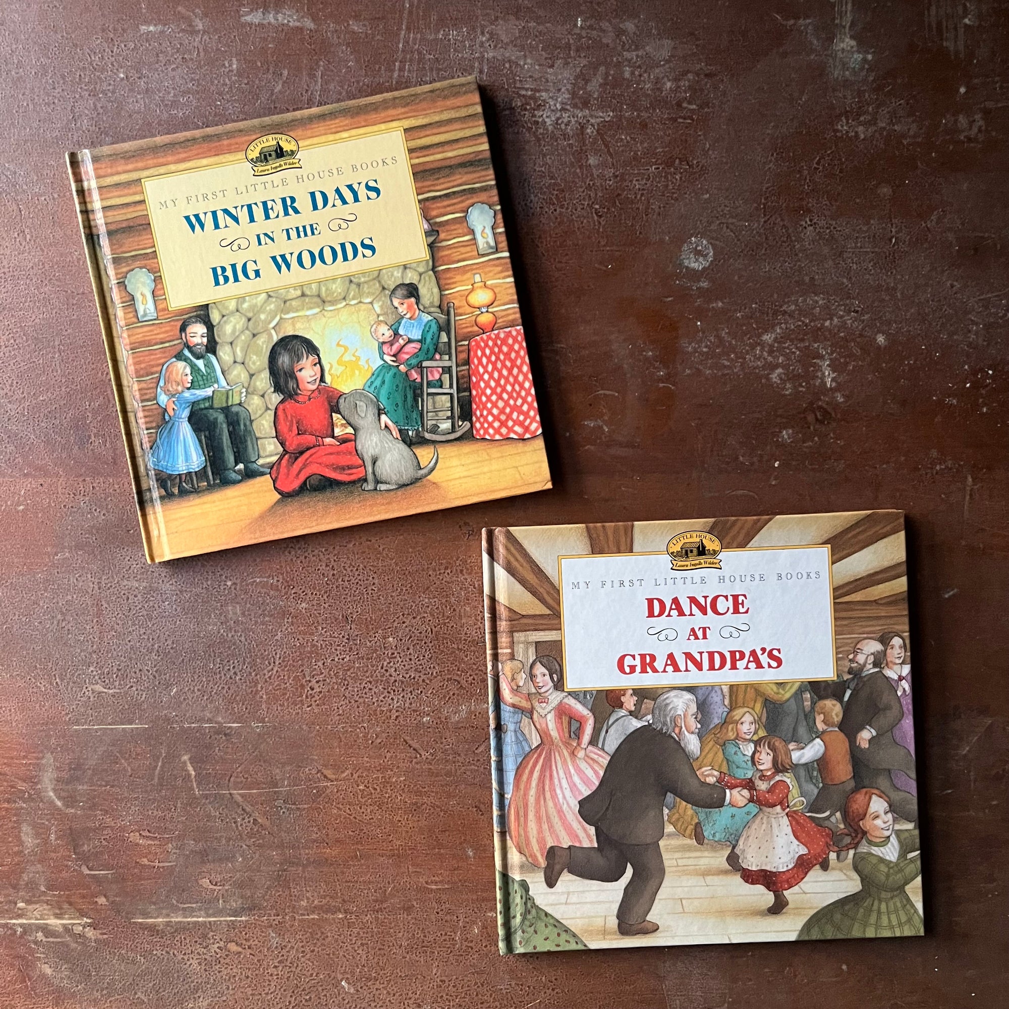 vintage picture books from Scholastic Inc. - My First Little House Books Set:  Winter Days in the Big Woods and Dance at Grandpa's written by Laura Ingalls Wilder with illustrations by Renee Graef - view of the front covers