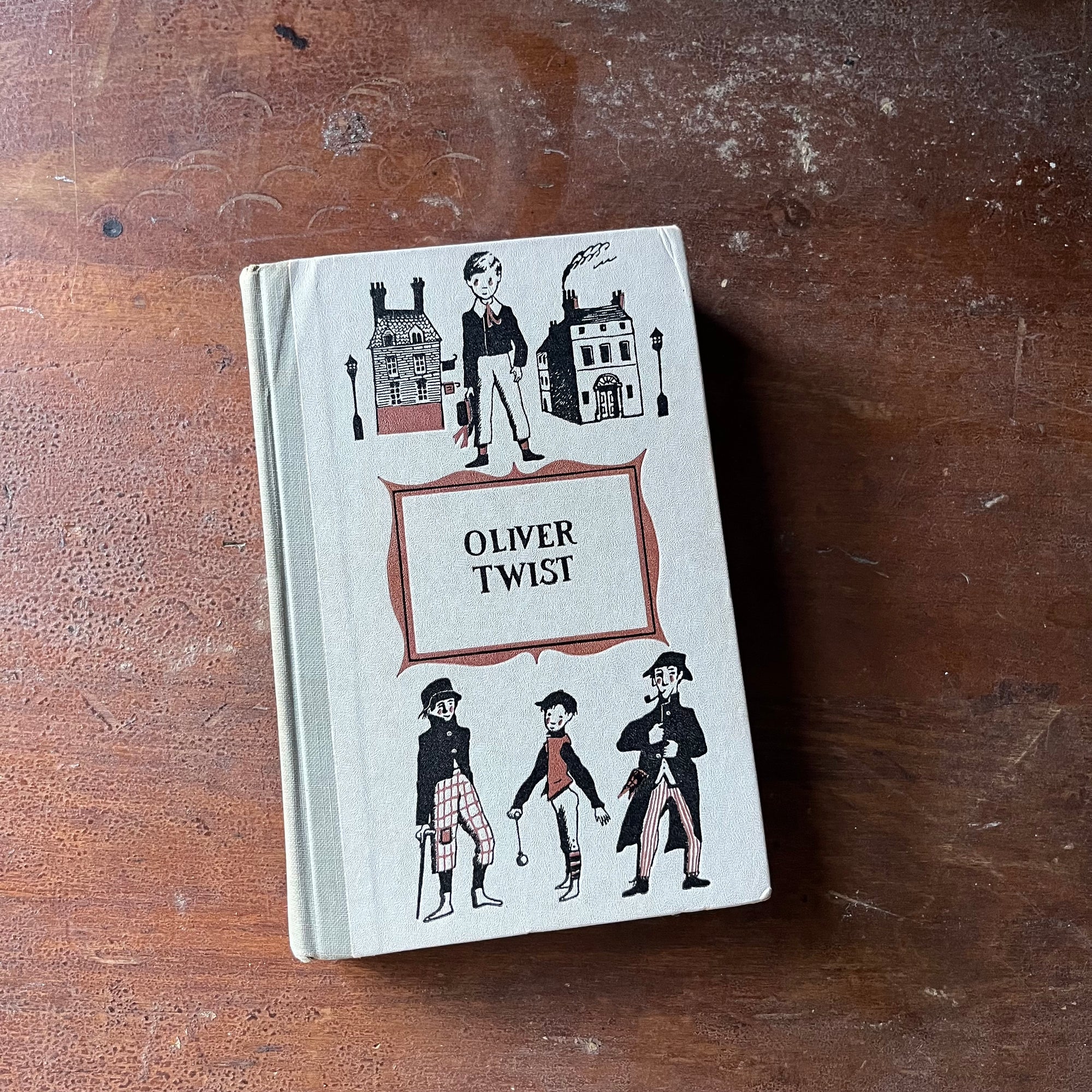 Junior Deluxe Editions Book, vintage children's chapter book - Oliver Twist written by Charles Dickens with illustrations by Lawrence Beall Smith - view of the embossed front cover