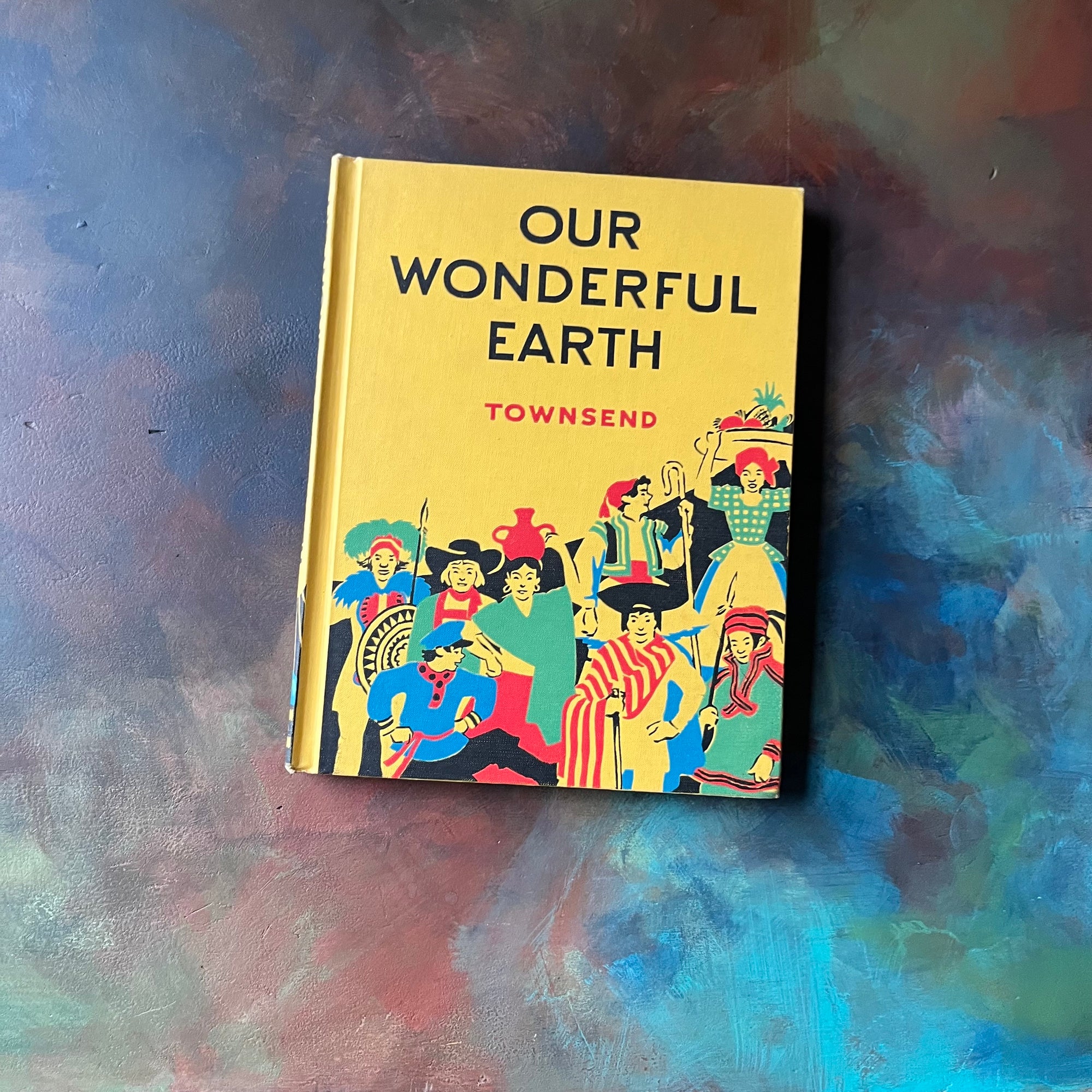Our Wonderful Earth-The Story of How It Became The Great Round Earth It Is Today-Written & Illustrated by Herbert Townsend-vintage children's science book-view of the front cover in bright yellow with an illustration of people from different cultures at the bottom