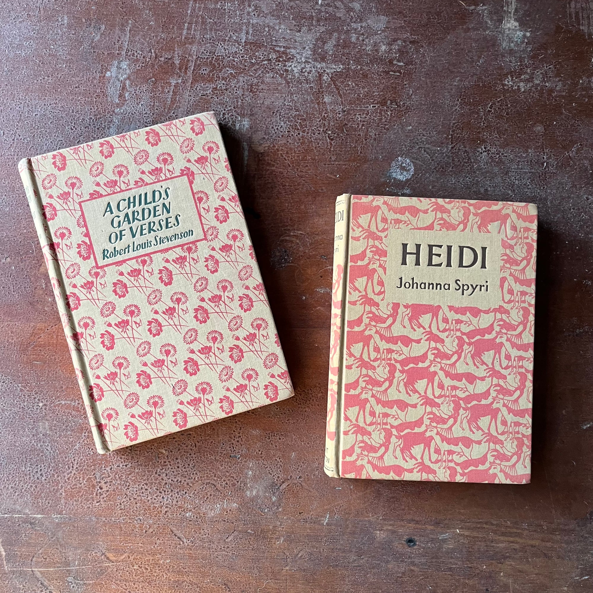 vintage children's books with decorative covers - Pair of Dent Dutton Books:  Heidi written by Johanna Spyri & A Child's Garden of Verses written by Robert Louis Stevenson - view of the embossed covers in shades of pink & cream