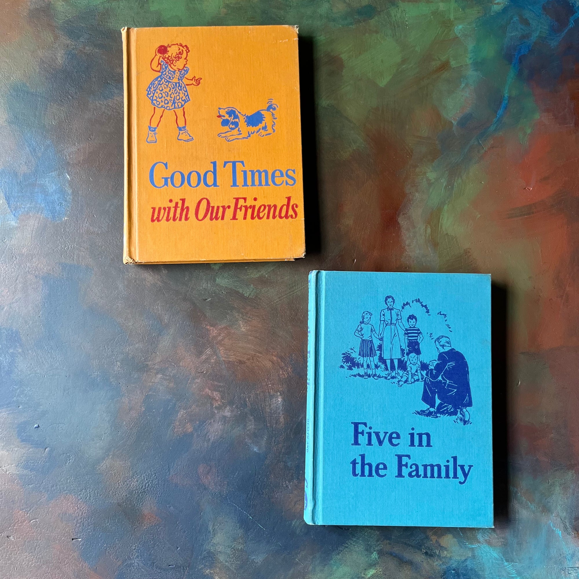 Pair of Health & Personal Development Curriculum Series-Good Times with Our Friends & Five in the Family-vintage schoolbooks-view of the front covers with illustrations & titles - one cover is orange & the other is blue