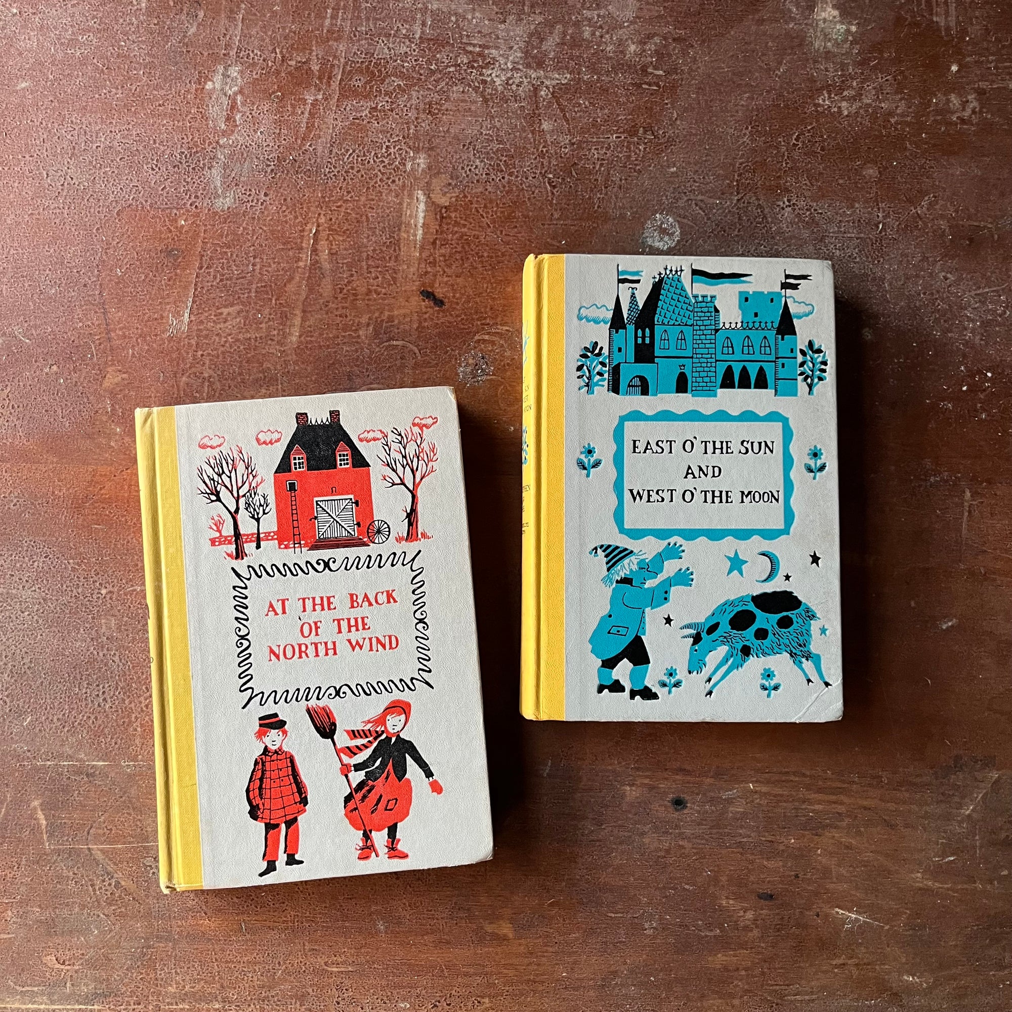 Pair of Junior Deluxe Editions-East O' The Sun and West O' the Moon and At The Back of the North Wind-vintage children's chapter books-view of the embossed front covers 