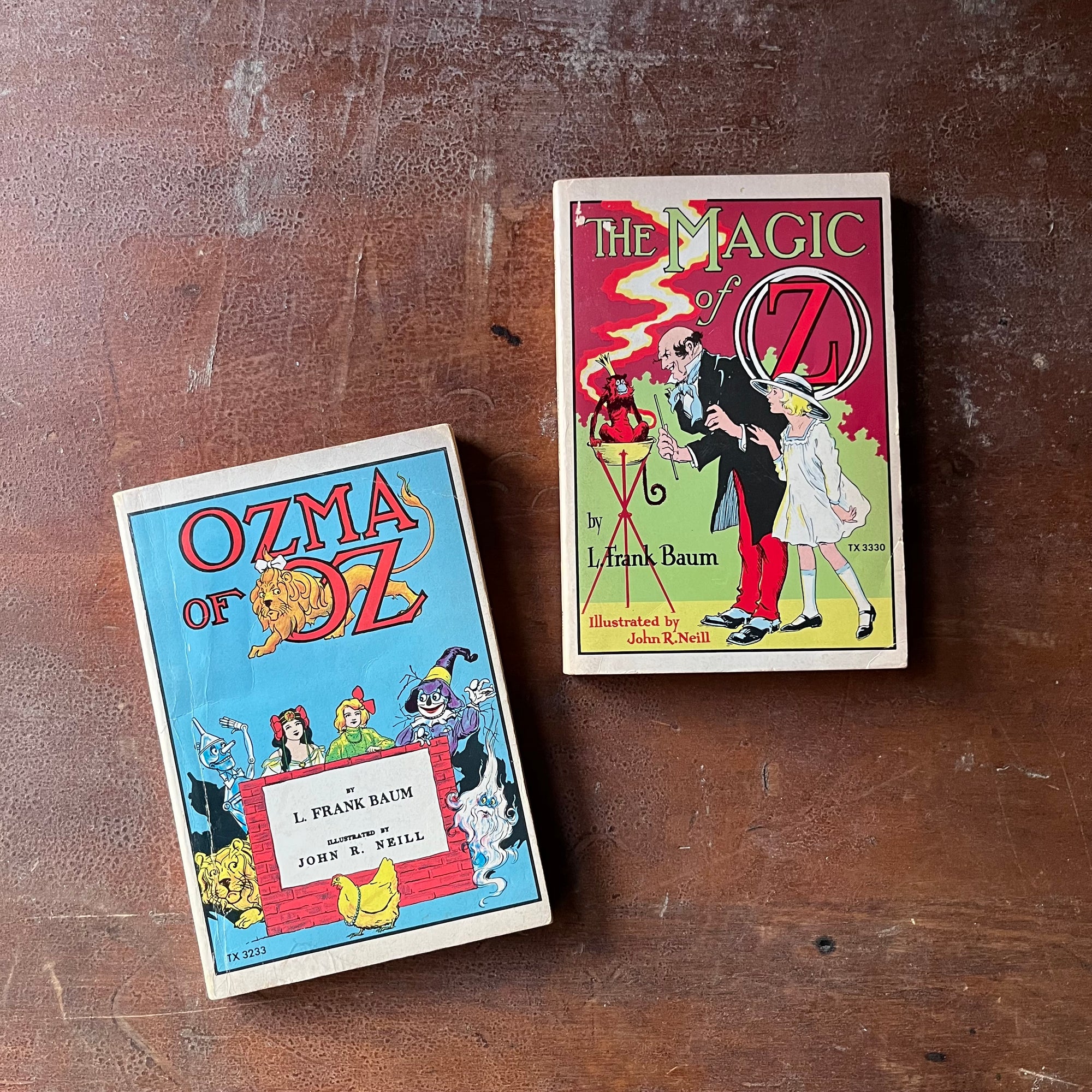 vintage children's chapter books, vintage Scholastic Books - Pair of L. Frank Baum Wizard of Oz Books: Ozma of Oz and The Magic of Oz - view of the colorful front covers