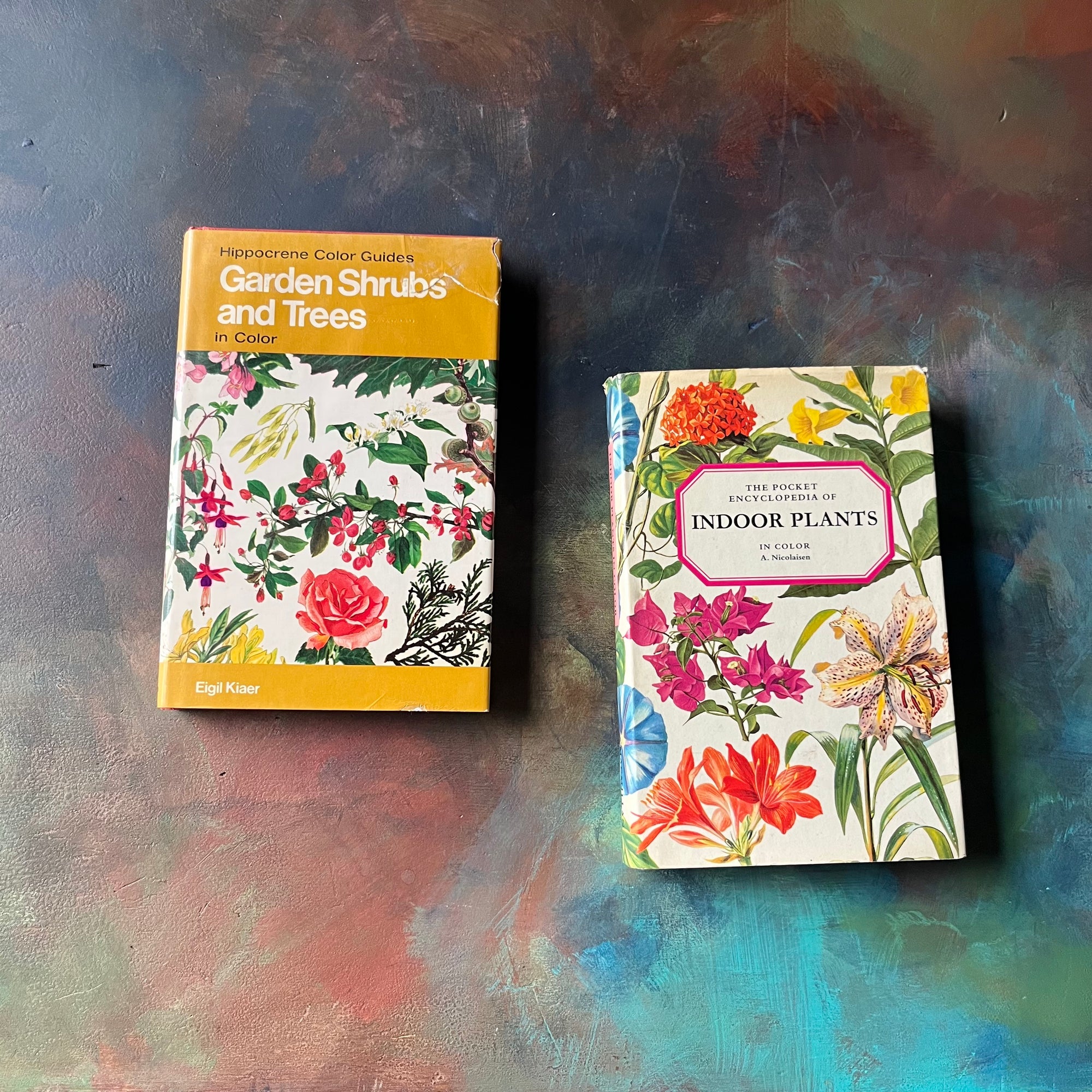 Pair of vintage plant books-Garden Shrubs & Trees and The Pocket Encyclopedia of Indoor Plants--vintage nature pocket guides-view of the dust jacket's front covers with colorful illustrations