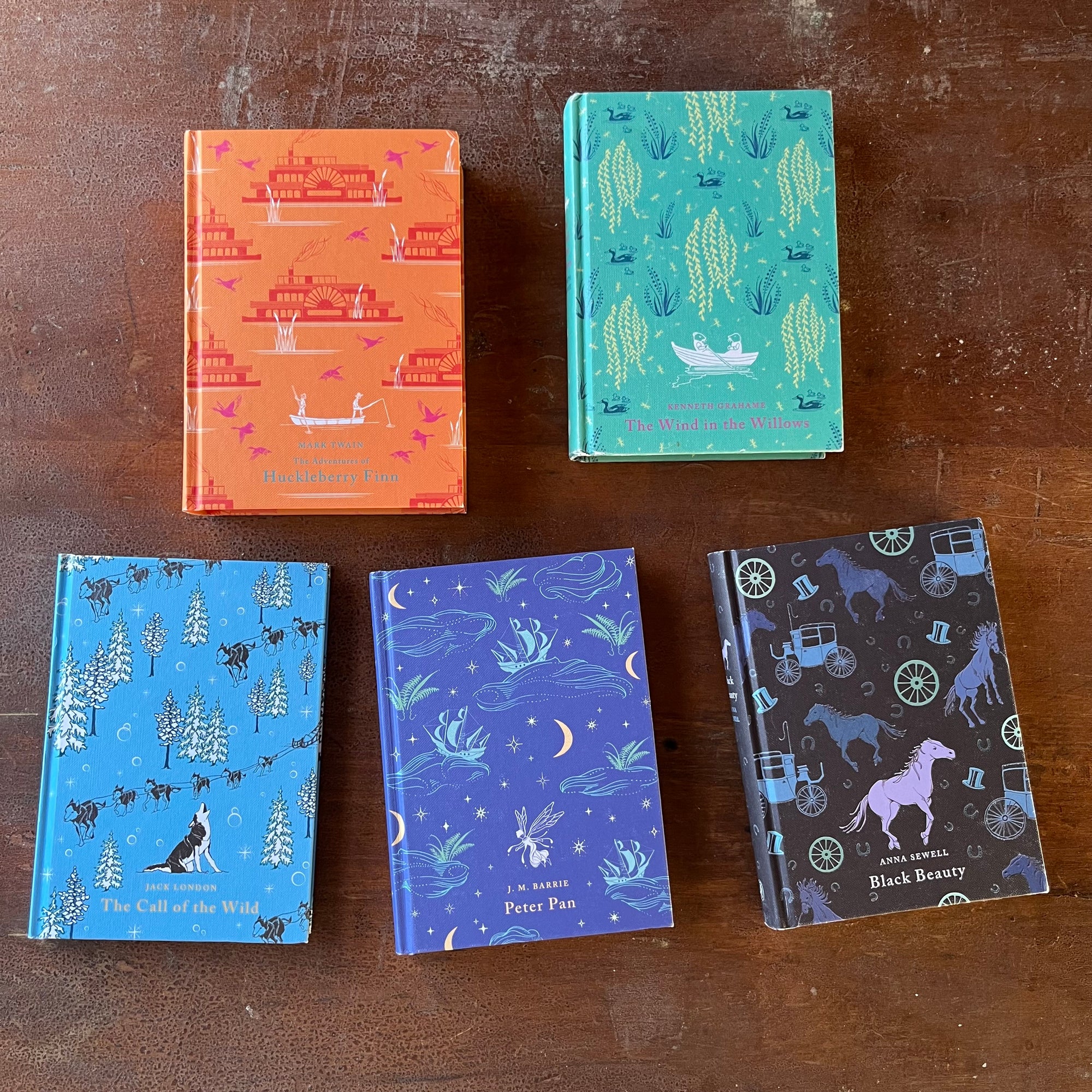 Puffin Children's Classics Book Set-5 Titles-The Adventures of Huckleberry Finn, The Wind in the Willows, The Call of the Wild, Black Beauty & Peter Pan-view of the decorative front covers created by Penguin designer Daniela Jaglenka Terrazini.