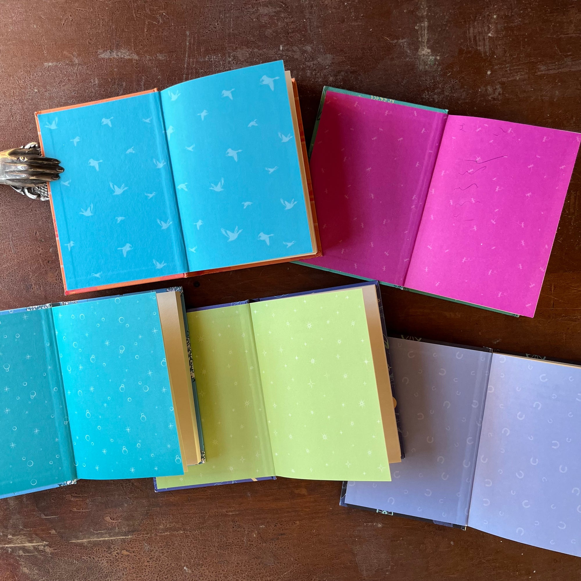 Puffin Children's Classics Book Set-5 Titles-The Adventures of Huckleberry Finn, The Wind in the Willows, The Call of the Wild, Black Beauty & Peter Pan-view of the inside covers in bright, colorful colors and design