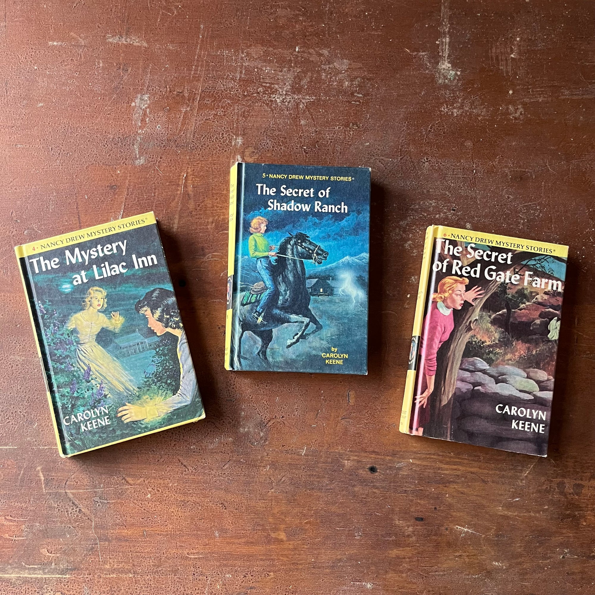 Set of Three Nancy Drew Mysteries by Carolyn Keene-The Mystery of Lilac Inn, The Secret of Shadow Ranch, and The Secret of Red Gate Farm-vintage children's chapter books-view of the front covers with illustrations of scenes from each book