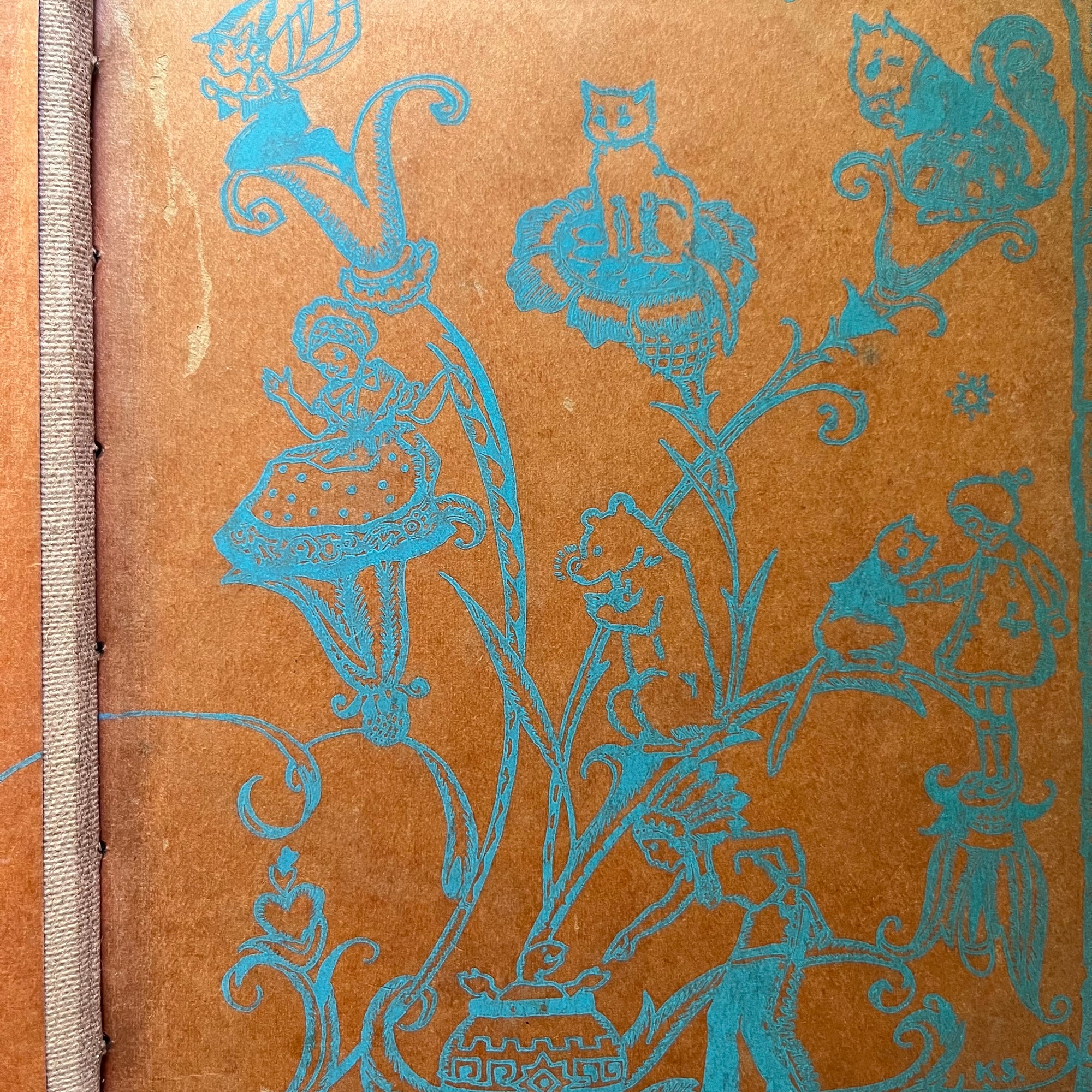Set of Three Vintage School Readers-Joyful Trails-Story Hour Readers Book Three-The Work-Play Books Friendly Stories-antique school books-closeup of the design on one inside cover in orange & blue showing images of the characters within the book