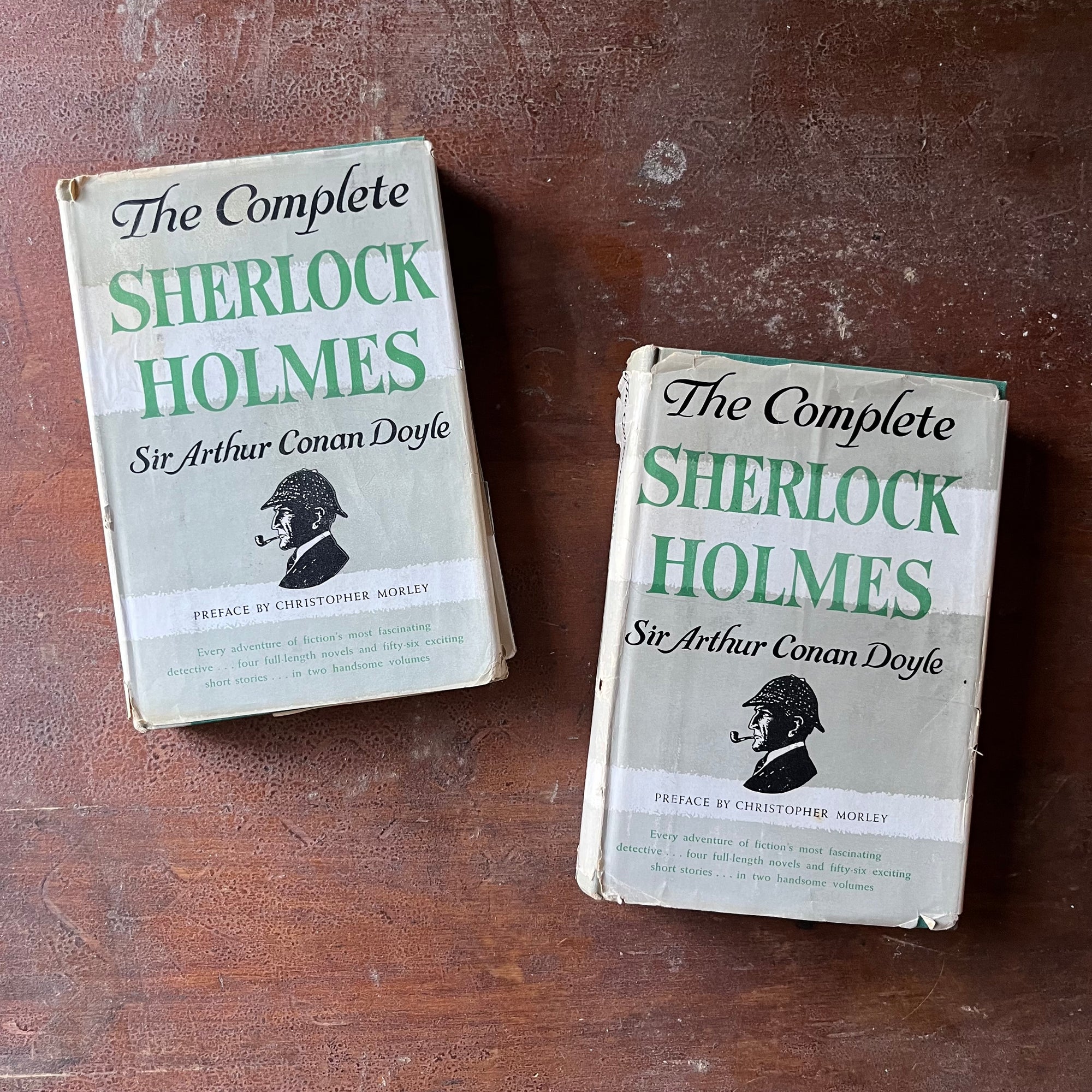 vintage mysteries - The Complete Sherlock Holmes Two Volume Book Set written by Sir Arthur Conan Doyle - view of the dust jacket's front cover with the iconic Sherlock Holmes profile of him in a hat smoking a pipe