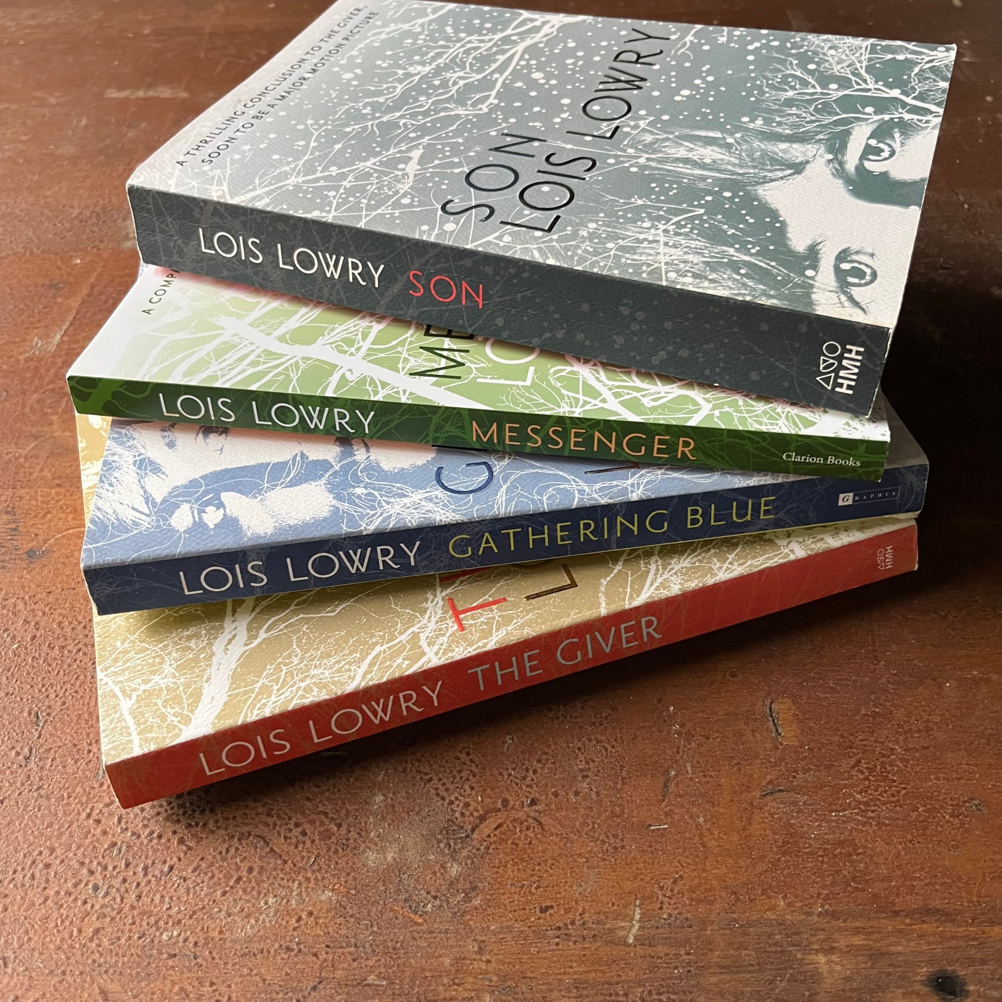 The Giver Quartet Book Set written by Lois Lowry-The Giver, Gathering Blue, Messenger, and Son-Newbery Award Winning Book-Dystopian Young Adult Science Fiction-view of the spines & partial view of the covers