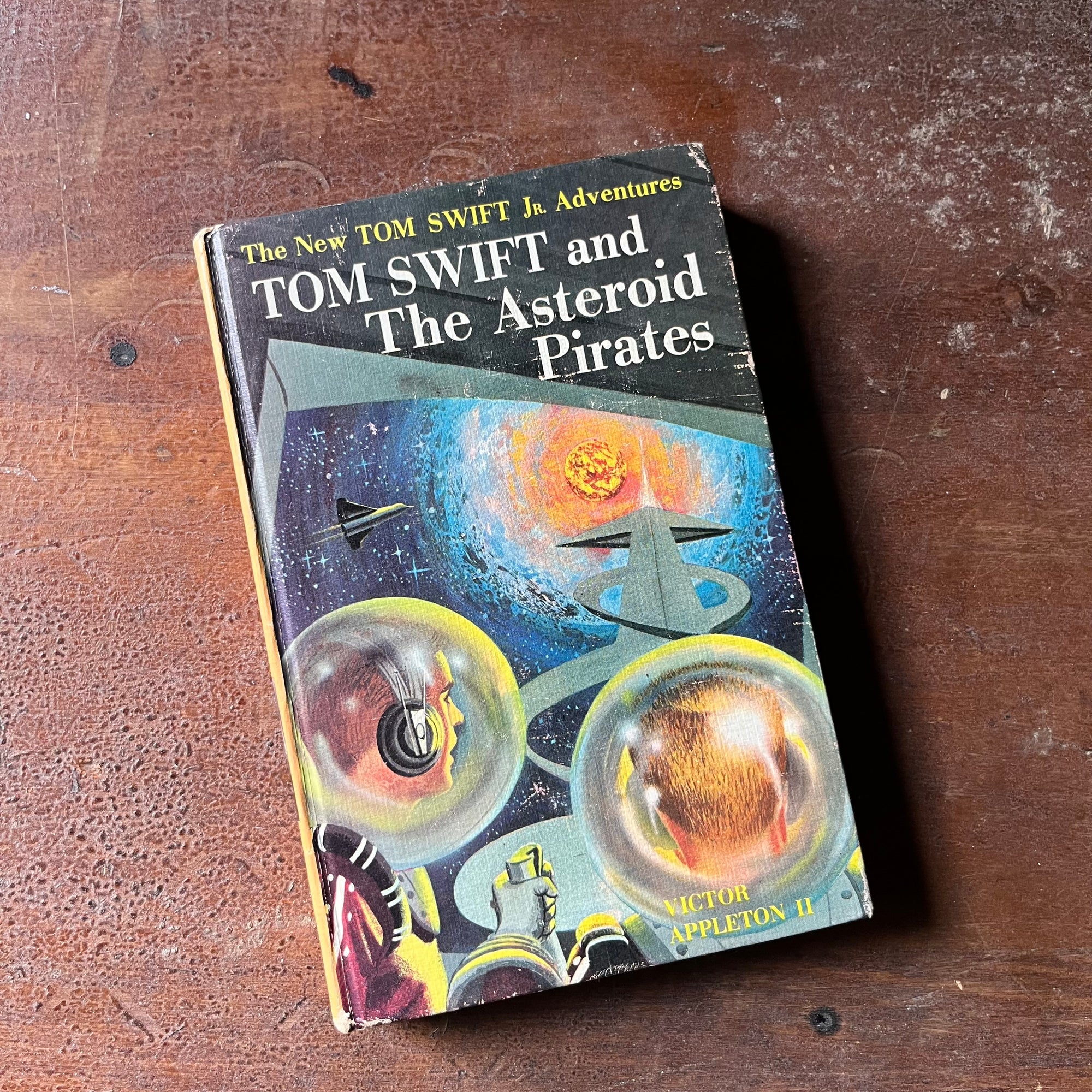 vintage children's adventure book, homeschool library, vintage boy adventure book, The New Tom Swift Jr. Adventures Book - Tom Swift and The Asteroid Pirates written by Victor Appleton II with illustrations by Charles Brey - view of the front cover