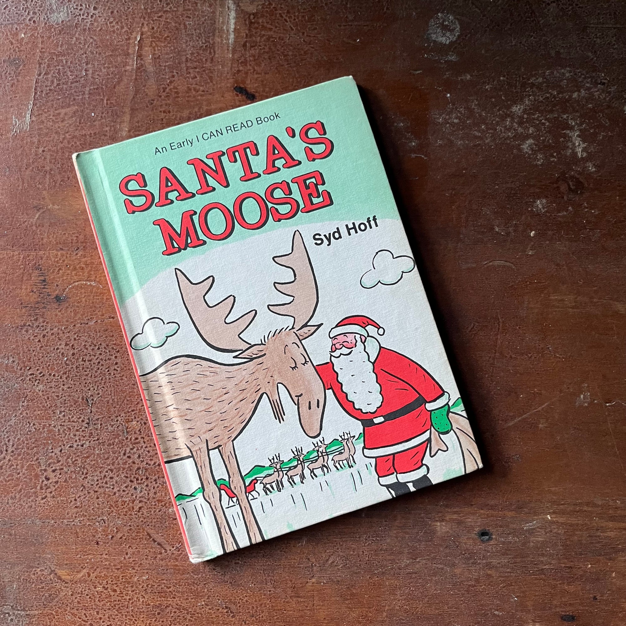 vintage children's picture book - Weekly Reader Books Presents Santa Moose, An Early I Can Read Book written & illustrated by Syd Hoff - view of the front cover with an illustration of Santa with the Moose (santa's reindeer are shown in the background)
