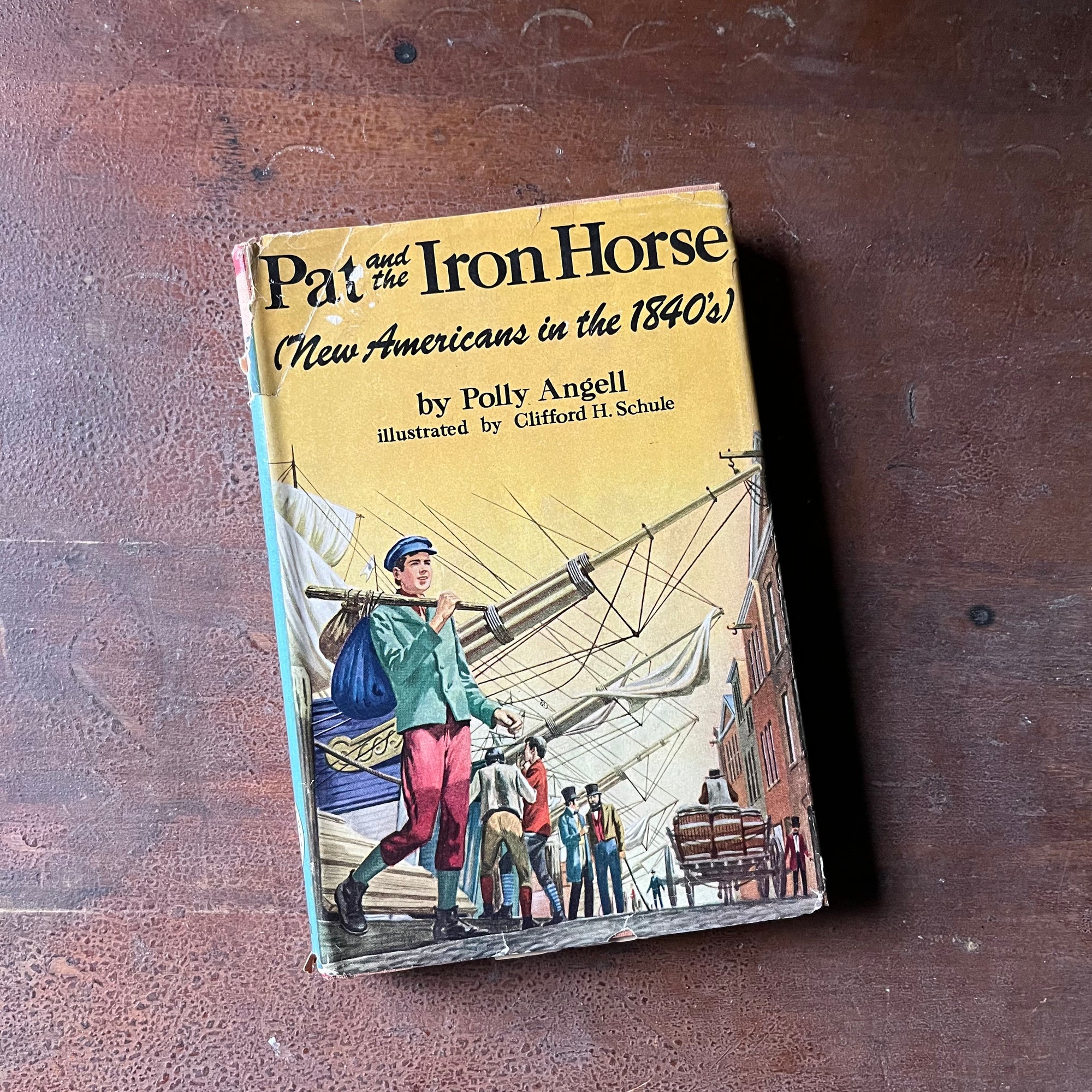 Log Cabin Vintage – vintage children’s book, children’s book, chapter book, American Heritage Series – Pat and the Iron Horse New Americans in the 1840's written by Polly Angell with illustrations by Clifford J. Schule - view of the dust jacket's front cover