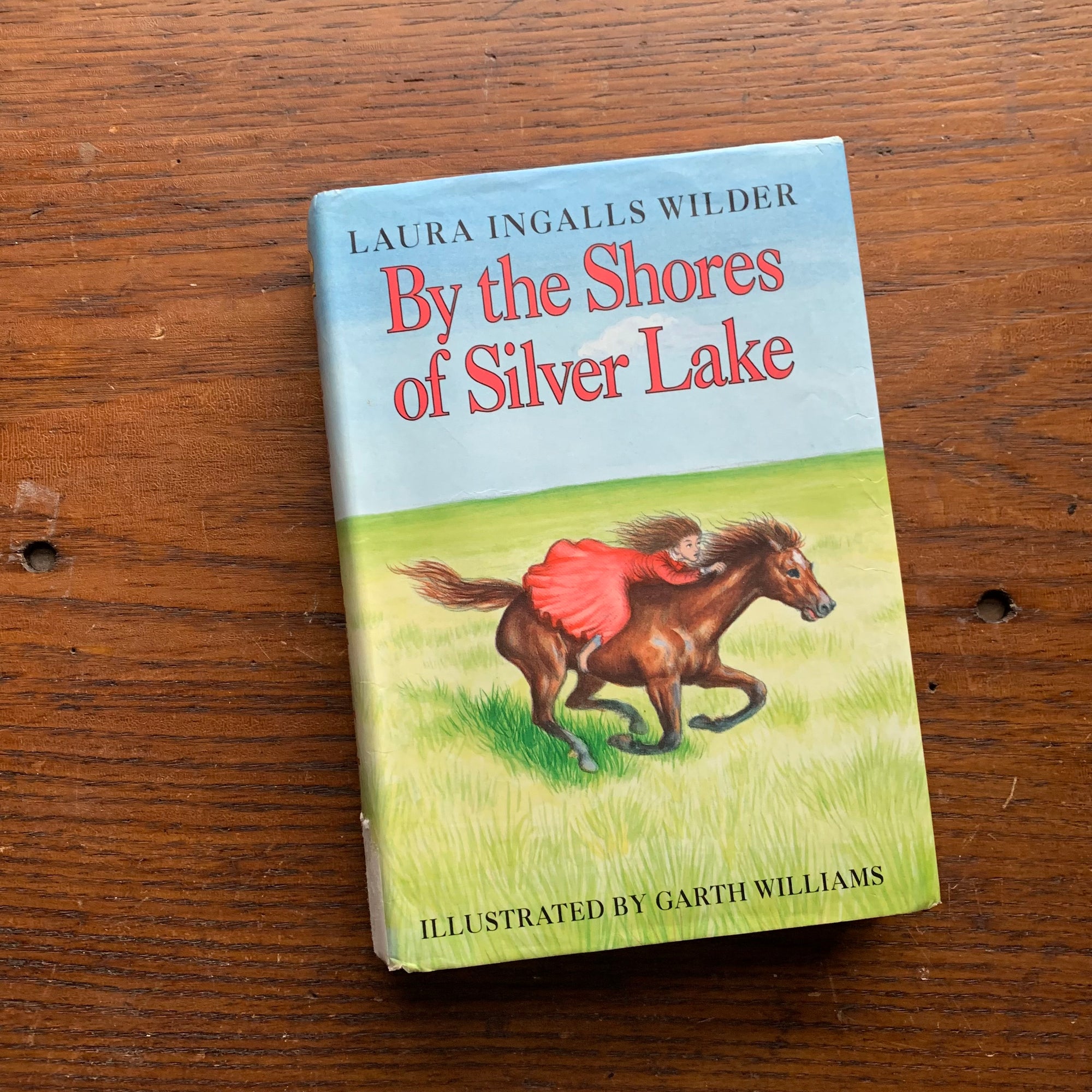 Log Cabin Vintage – vintage children’s book, children’s book, chapter book, Little House on the Prairie Series – By the Shores of Silver Lake by Laura Ingalls Wilder with Illustrations by Garth Williams - view of the dust jacket's front cover