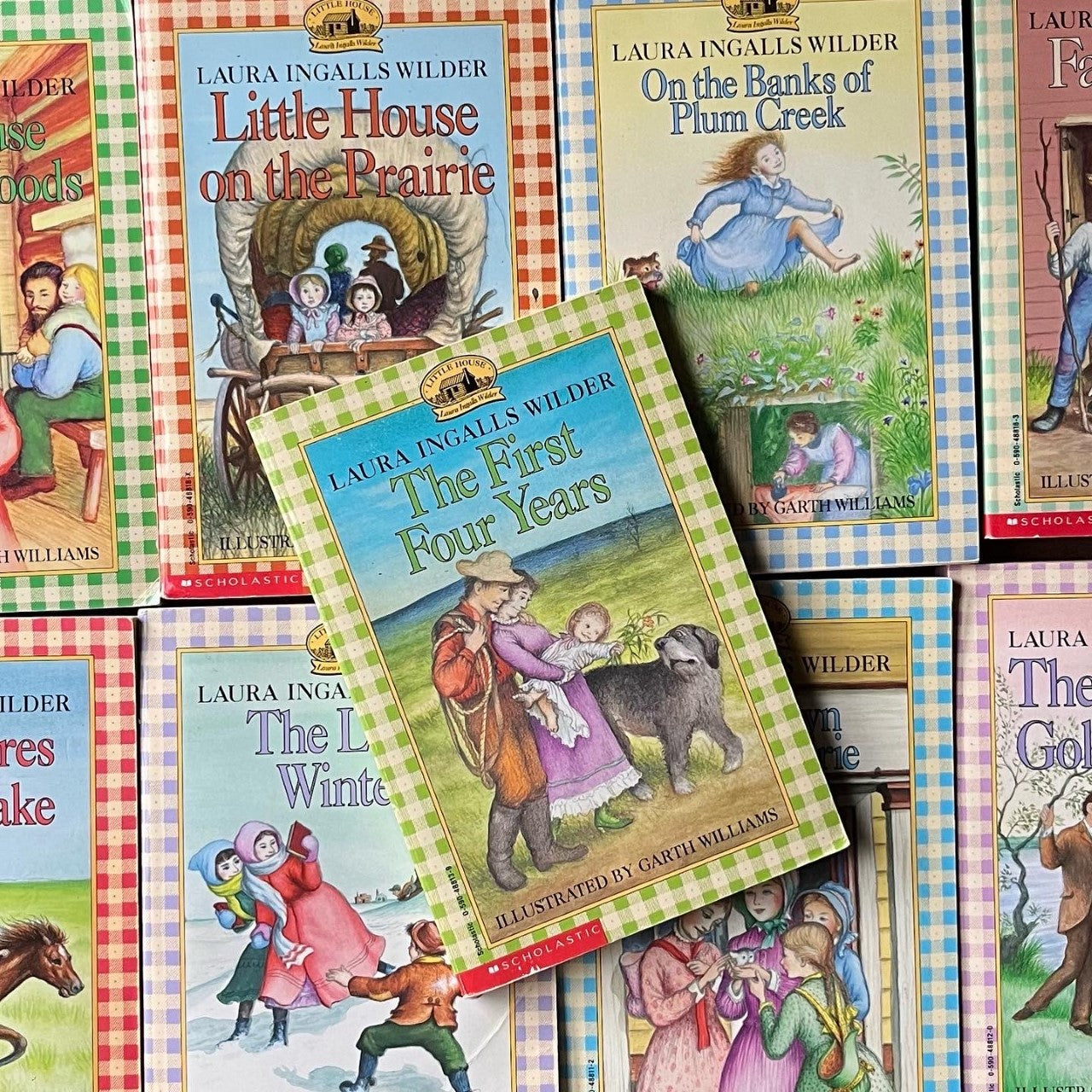 a collage of Little House on the Prairie book series book covers in plaid/gingham from Scholastic Books