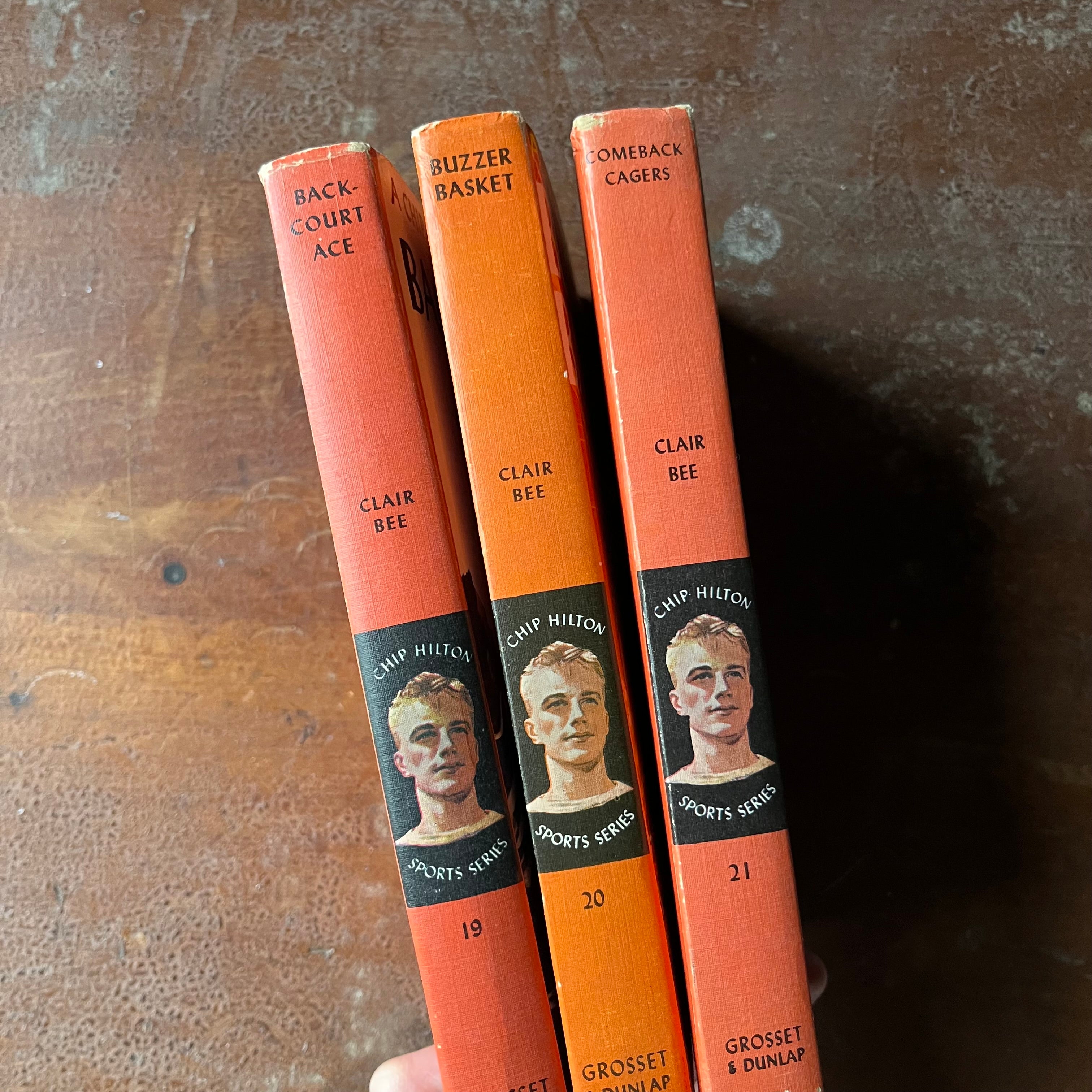 A Chip Hilton Sports Story Book Set-Backcourt Ace, Buzzer Basket & Comeback Cagers by Clair Bee-vintage children's chapter books-view of the spines in different shades of orange with title, author, publisher & an image of Chip Hilton in the middle with the name of the series around the illustration - the books are also numbered under the illustration