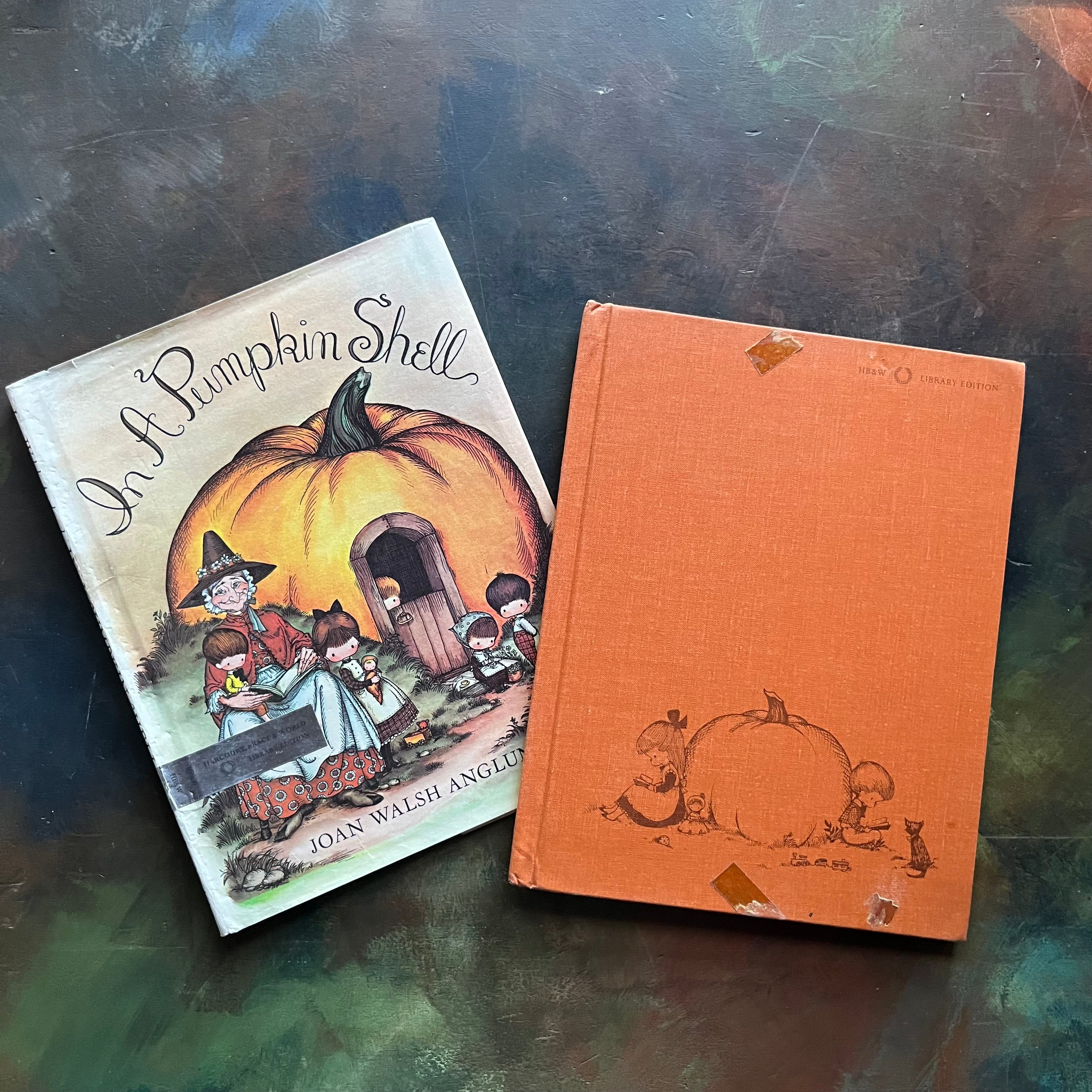A Mother Goose ABC In a Pumpkin Shell written & illustrated by Joan Walsh Anglund-vintage children's picture book-view of the front cover in orange with two children leaning against a pumpkin - both reading
