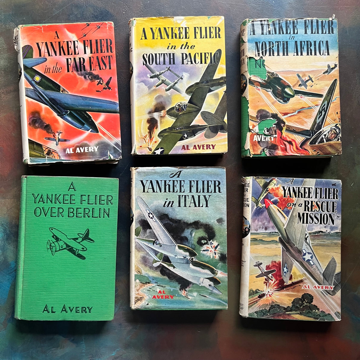 A Set of Six Yankee Flier Books by Al Avery-Air Combat Stories for Boys-antique warplane books-view of the front covers with dust jackets depicting different planes