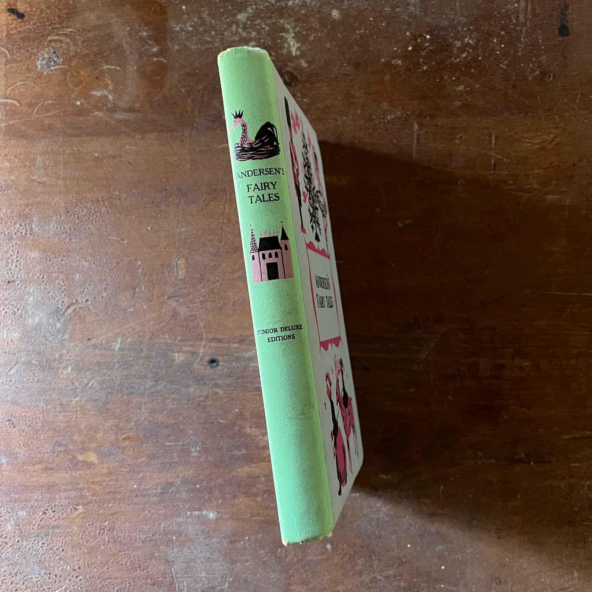 vintage children's chapter book - Andersen's Fairy Tales-A Junior Deluxe Editions Book - view of the embossed spine in green with pink & black illustrations