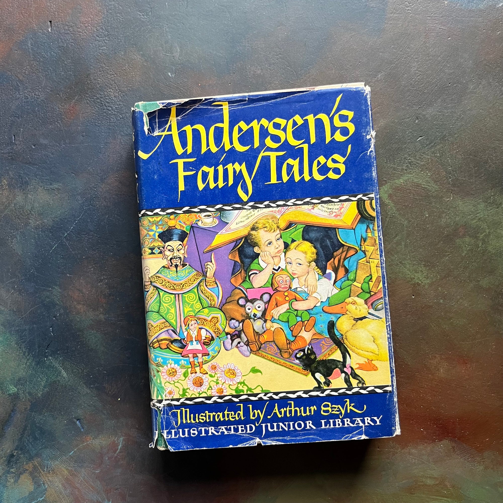 Andersen's Fairy Tales-vintage children's fairy tales & classics-Illustrated Junior Deluxe Editions-view of the dust jacket's front cover with a colorful illustration of images from the stories within the pages