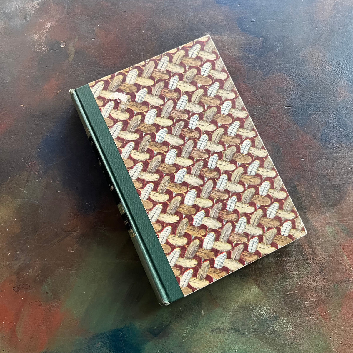 Audubon’s Birds of America Popular Edition, 1950 by John James Audubon-view of the front cover decorated with a feather image with feathers crisscrossing across the cover