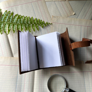 Blank Leather Travel Journals - handmade leather journal - view of the bright white, hand-torn paper inside the darker cover journal