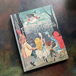 Dean's A Book of Fairy Tales-Janet and Anne Grahame Johnstone Illustrations-Hans Christian Andersen Fairy Tales-view of the front cover with an image of children dancing and waving at Mother Goose as she flies past