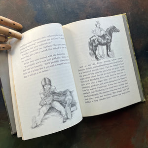 Doodlebug written and illustrated by Irene Brady was part of the vintage Weekly Reader Book Series for children transitioning from picture books to chapter books-early chapter book-view of the illustrations in the book of Jennifer and the black stallion named Doodlebug
