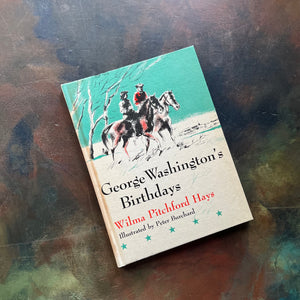 Goerge Washington's Birthdays written by Wilma Pitchfod Hays-with illustrations by Peter Burchard - A Weekly Reader Books-Young Washington Biography-view of the front cover with an image of George riding his horse, Firebrand with another rider - there are 5 blue stars at the bottom of the cover as well as the title, author and illustrator listed