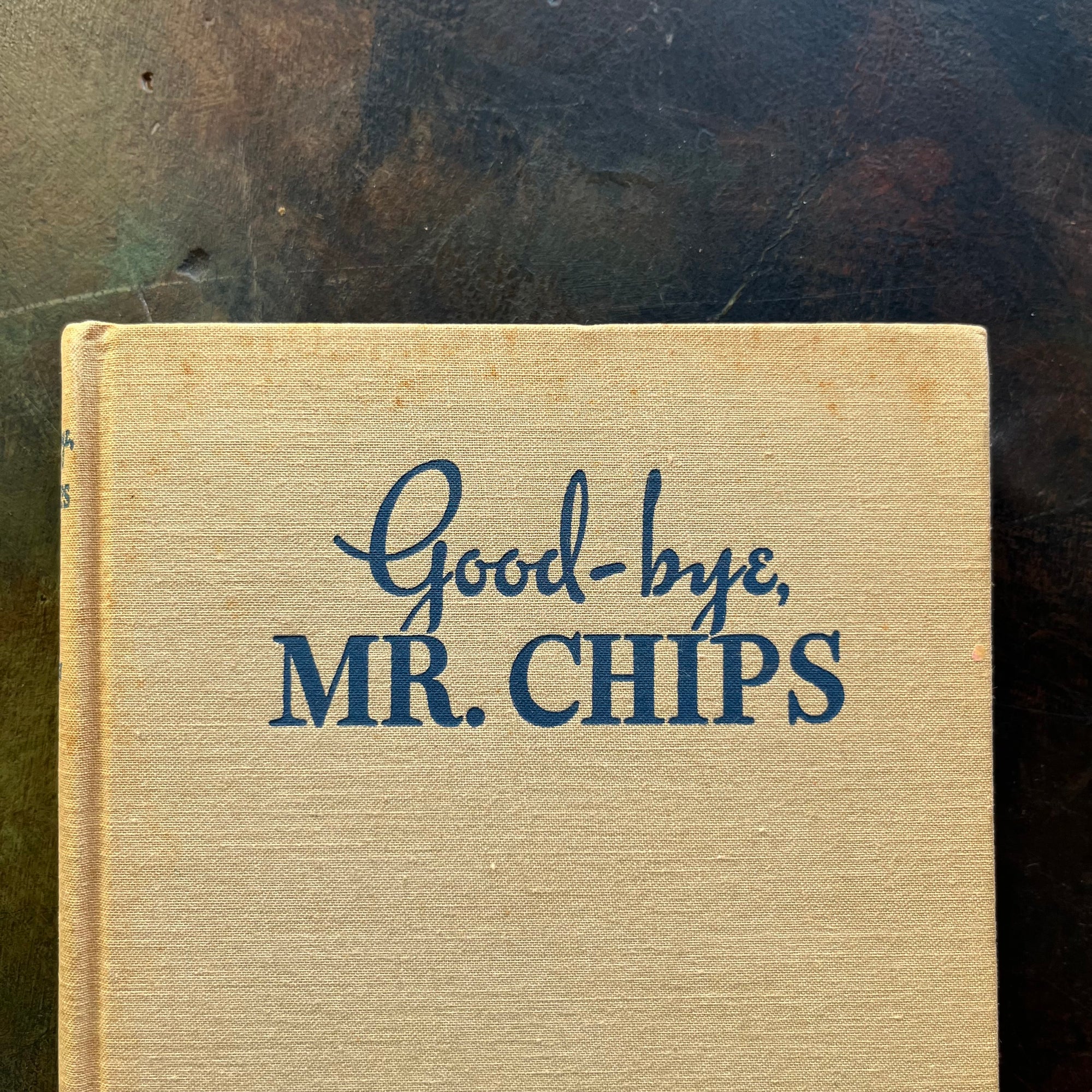 Good-Bye Mr. Chips written by James Hilton-Classic British Literature-vintage novella-heartwarming, wholesome story-closeup view of the foxing noted at the top of the book cover