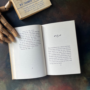 Good-Bye, Mr. Chips by James Hilton-British novella-First Edition-antique book-view of the inside content of the book being held open by a wooden hand