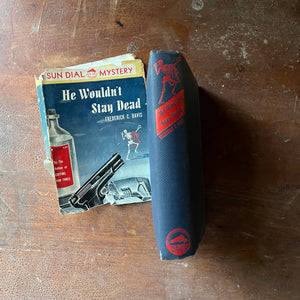 A Sundial Mystery, vintage mystery novel  - He Wouldn't Stay Dead written by Frederick C. Davis - view of the spine with the title written in red along with a red dancing skeleton (same as on the dust jacket)