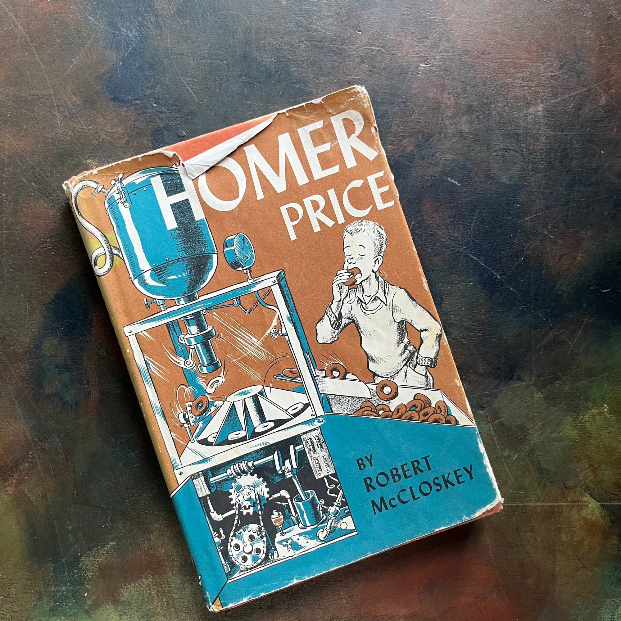 Homer Price-Robert McCloskey-vintage children's chapter book-humorous family read-aloud-vintage children's chapter book-view of the dust jacket's front cover depicting the scene in the book where Homer is eating donuts from the donut machine