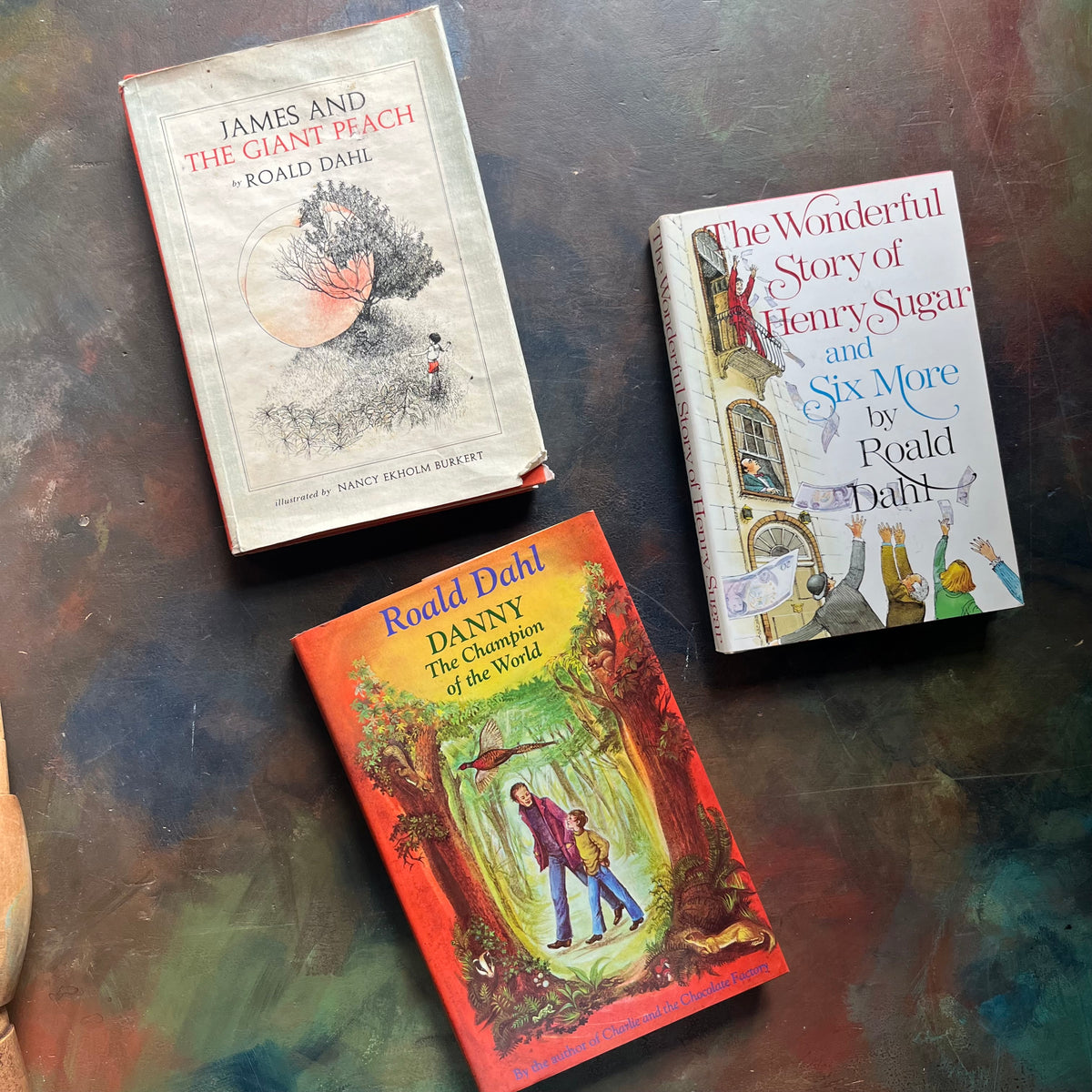 James and the Giant Peach-Danny Champion of the World-The Wonderful Story of Henry Sugar-vintage Roald Dahl Books-vintage Roald Dahl children's chapter books-classic children's books-view of the dust jacket's covers with images from each of the books depicted on the covers