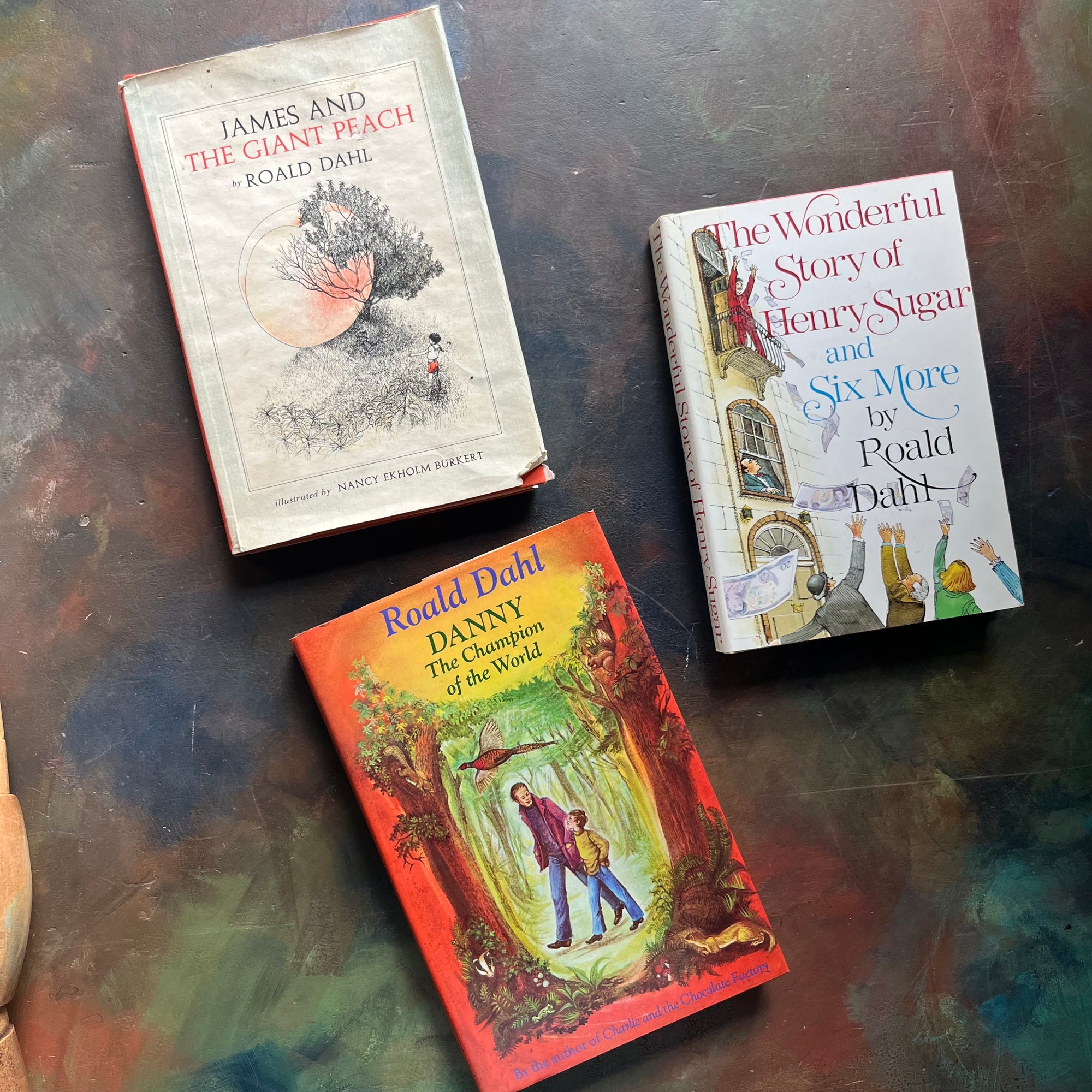 James and the Giant Peach-Danny Champion of the World-The Wonderful Story of Henry Sugar-vintage Roald Dahl Books-vintage Roald Dahl children's chapter books-classic children's books-view of the dust jacket's covers with images from each of the books depicted on the covers