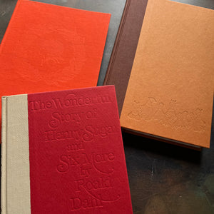 James and the Giant Peach-Danny Champion of the World-The Wonderful Story of Henry Sugar-vintage Roald Dahl Books-vintage Roald Dahl children's chapter books-classic children's books-view of the closeup up view of the embossing on each of the clothbound front covers - James and the Giant Peach is hard to see but the embossing is there