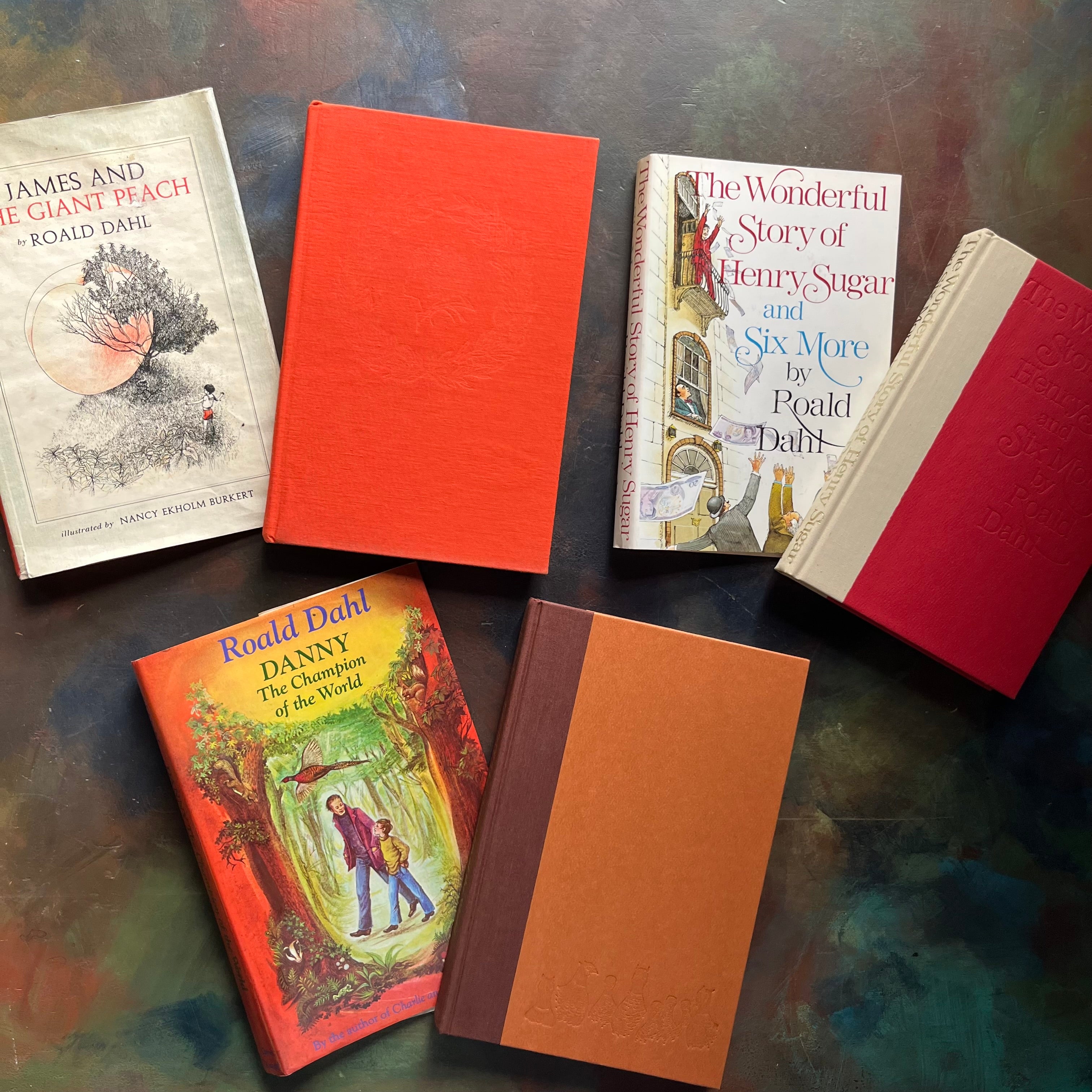 James and the Giant Peach-Danny Champion of the World-The Wonderful Story of Henry Sugar-vintage Roald Dahl Books-vintage Roald Dahl children's chapter books-classic children's books-view of the front covers sitting next to their dust jackets