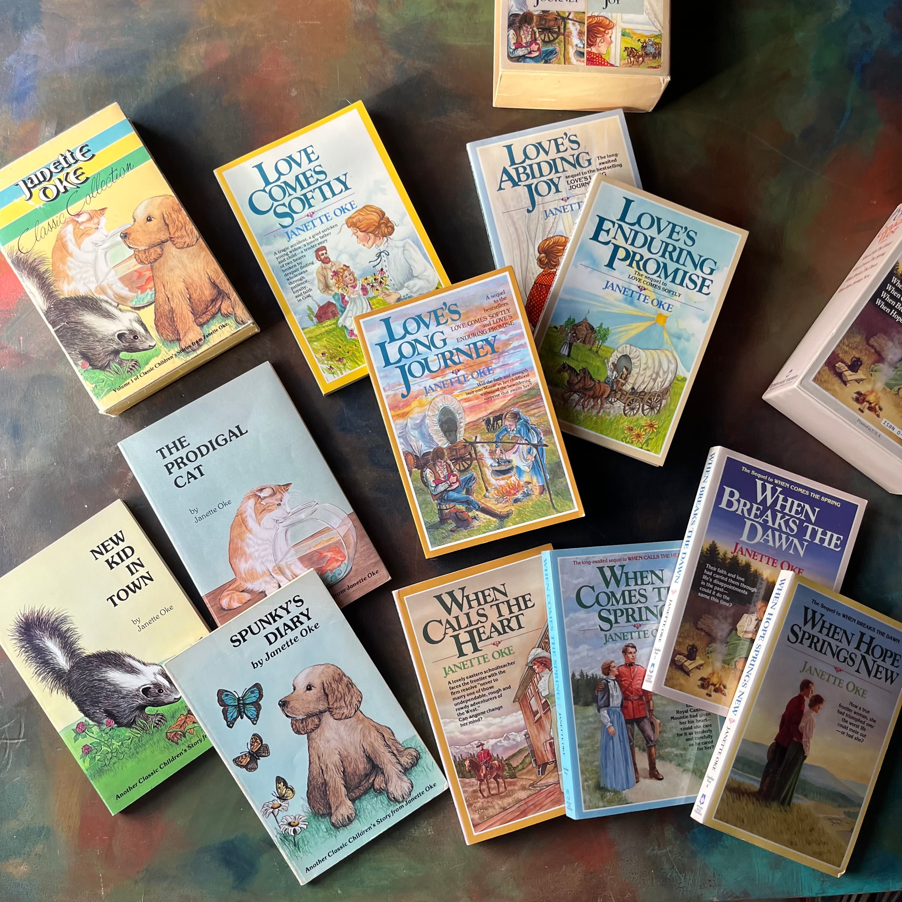 Janette Oke Book Set-Canadian West Series-Prairie Romance Series-Classic Collection-vintage Christian Fiction-spines-view of the front covers with the book sleeves in the background