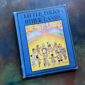 Little Folks of Other Lands written by Watty Piper-with illustrations by Lucille and Holling C. Holling-vintage world geography study-vintage children's book-view of the front cover with an illustration of children holding hands in a circle